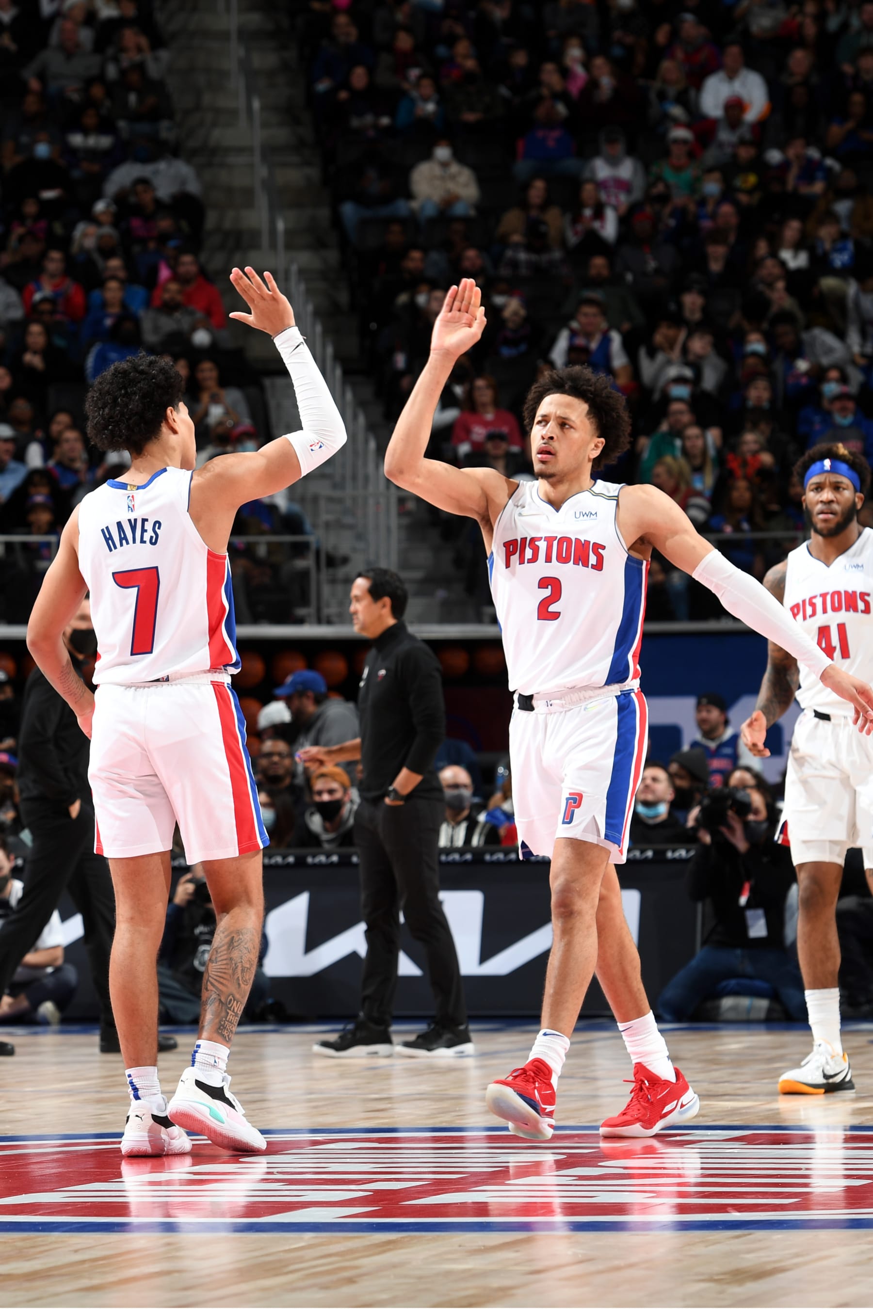 DETROIT, MI - DECEMBER 19: Killian Hayes #7 and Cade Cunningham #2 of the Detroit Pistons high five during the game against the Miami Heat on December 19, 2021 at Little Caesars Arena in Detroit, Michigan. NOTE TO USER: User expressly acknowledges and agrees that, by downloading and/or using this photograph, User is consenting to the terms and conditions of the Getty Images License Agreement. Mandatory Copyright Notice: Copyright 2021 NBAE (Photo by Chris Schwegler/NBAE via Getty Images)