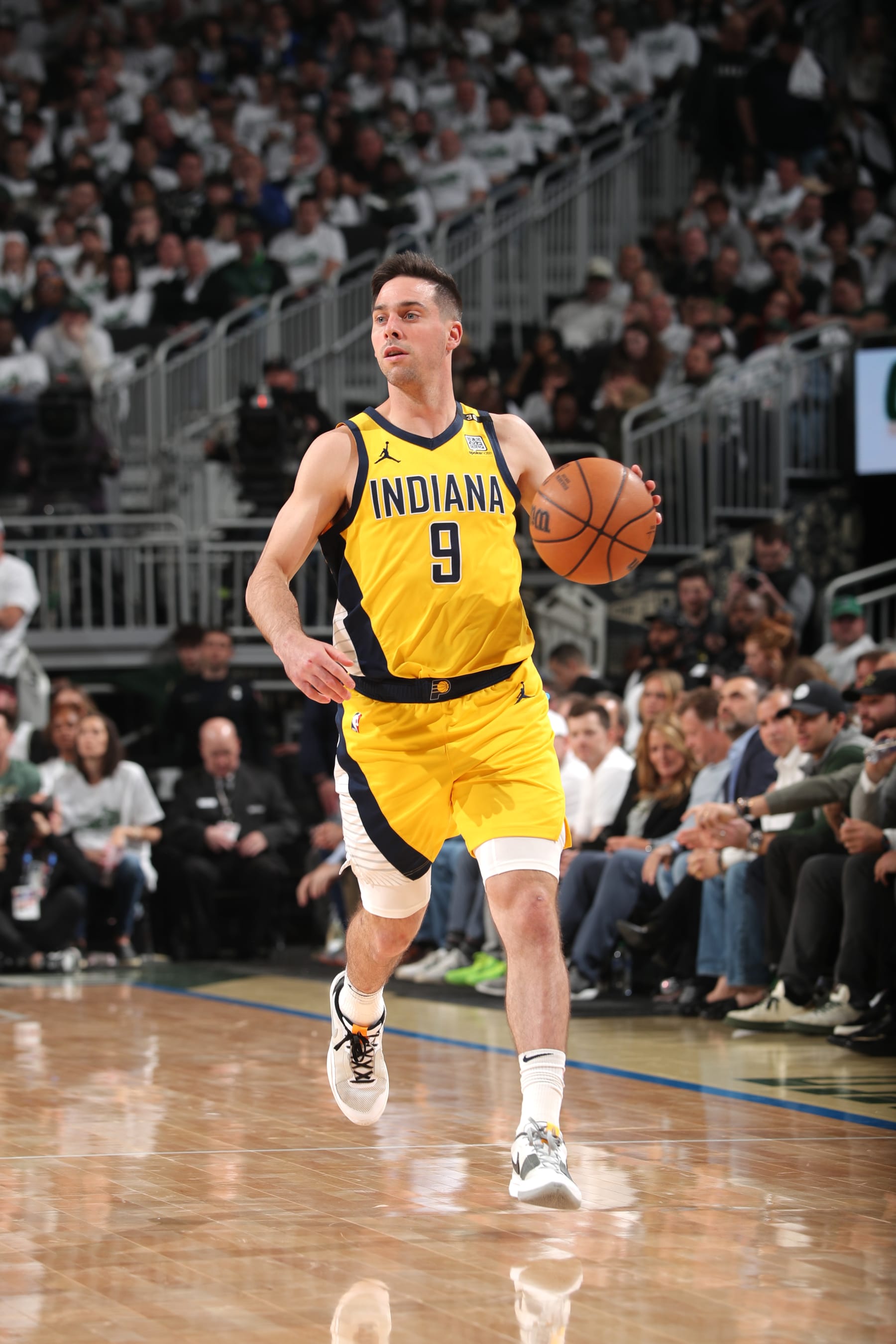 MILWAUKEE, WI - APRIL 23: T.J. McConnell #9 of the Indiana Pacers dribbles the ball during the game against the Milwaukee Bucks during Round One Game Two of the 2024 NBA Playoffs on April 23, 2024 at the Fiserv Forum Center in Milwaukee, Wisconsin. NOTE TO USER: User expressly acknowledges and agrees that, by downloading and or using this Photograph, user is consenting to the terms and conditions of the Getty Images License Agreement. Mandatory Copyright Notice: Copyright 2024 NBAE (Photo by Gary Dineen/NBAE via Getty Images).