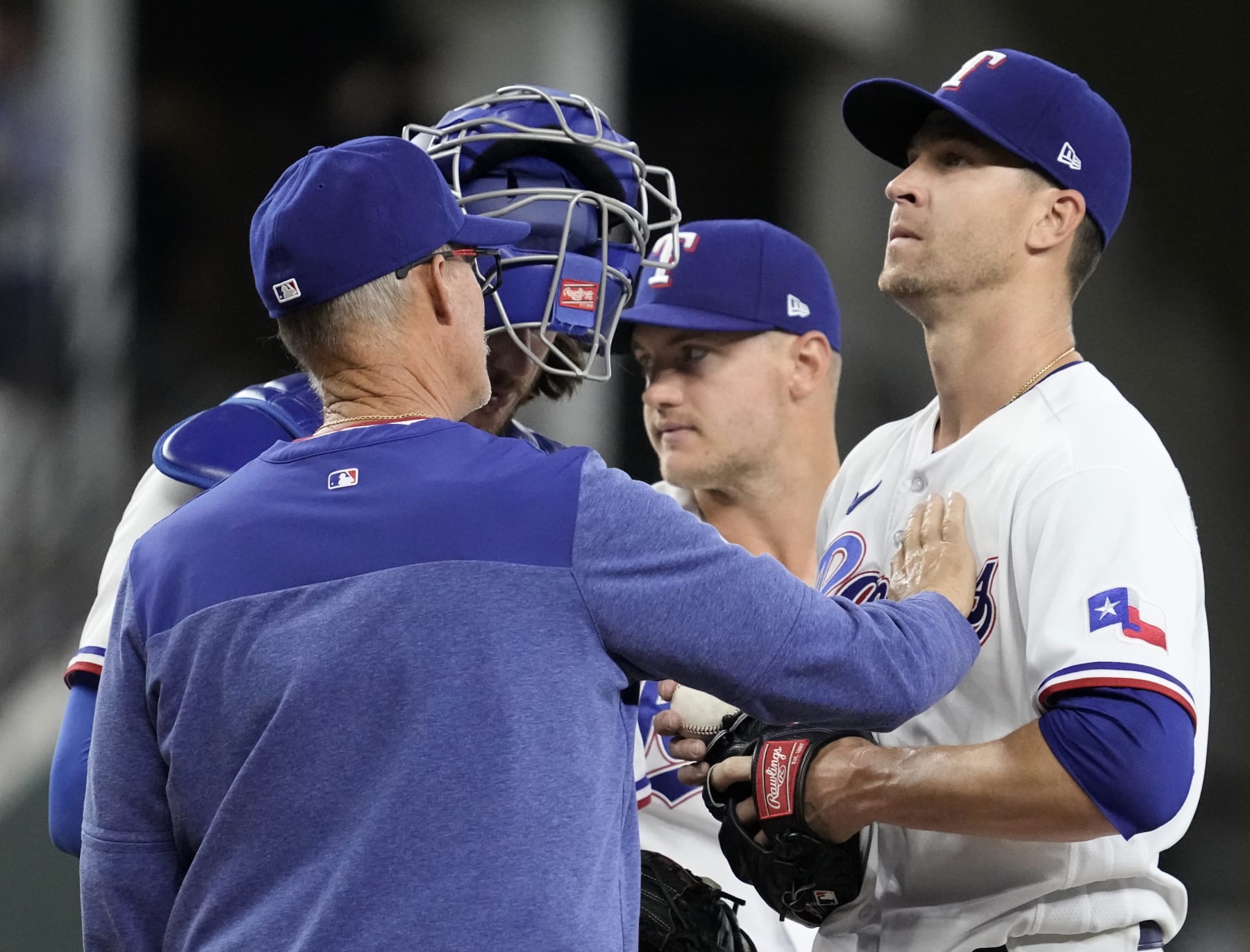 ARLINGTON, TEXAS - APRIL 05: Pitching coach Mike Maddux #31 of the Texas Rangers touches the chest of Jacob deGrom #48 of the Texas Rangers during the fifth inning against the Baltimore Orioles at Globe Life Field on April 05, 2023 in Arlington, Texas. (Photo by Sam Hodde/Getty Images)