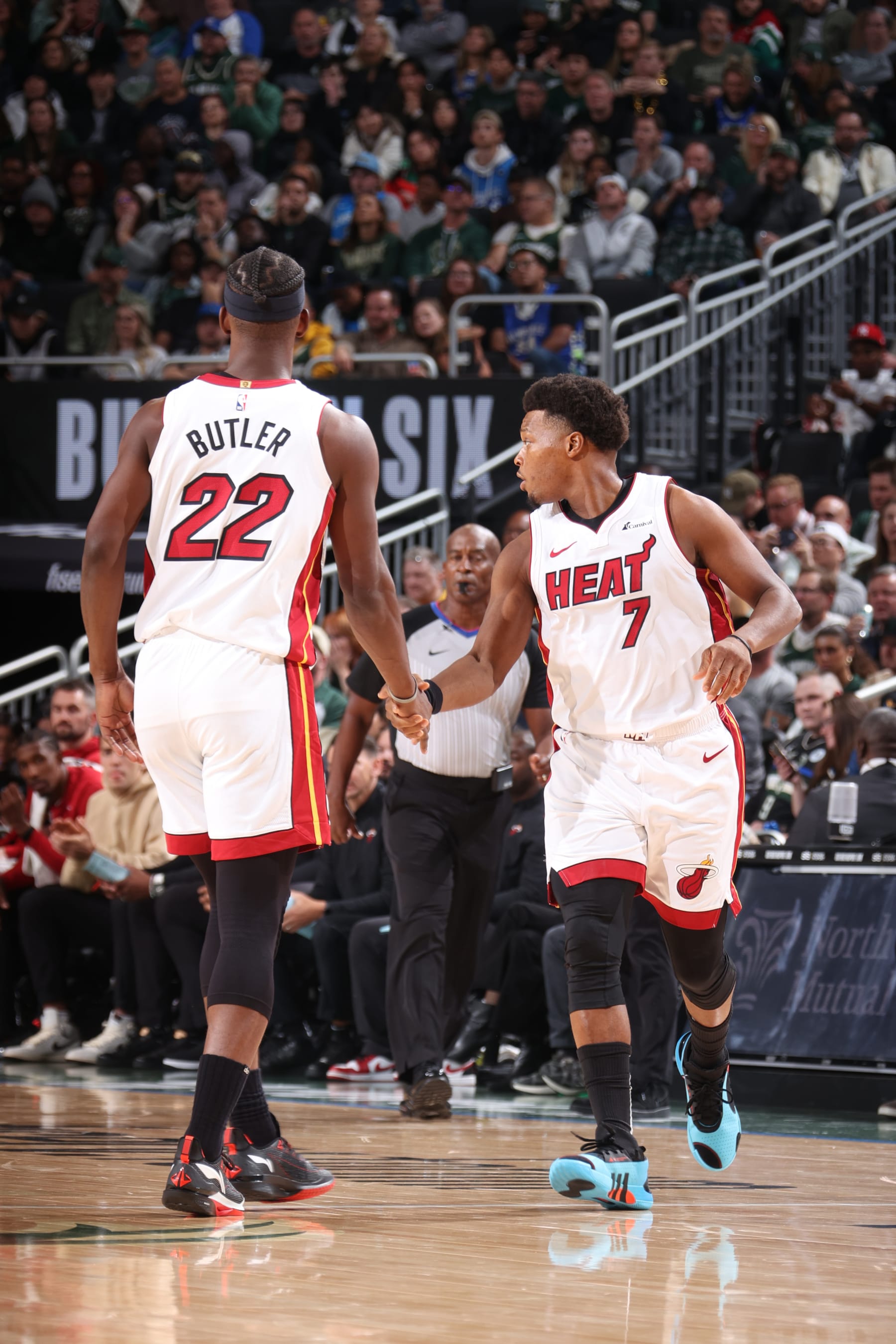 MILWAUKEE, WI - OCTOBER 30: Jimmy Butler #22 shakes hands with Kyle Lowry #7 of the Miami Heat during the game against the Milwaukee Bucks on October 30, 2023 at the Fiserv Forum Center in Milwaukee, Wisconsin. NOTE TO USER: User expressly acknowledges and agrees that, by downloading and or using this Photograph, user is consenting to the terms and conditions of the Getty Images License Agreement. Mandatory Copyright Notice: Copyright 2023 NBAE (Photo by Nathaniel S. Butler/NBAE via Getty Images).
