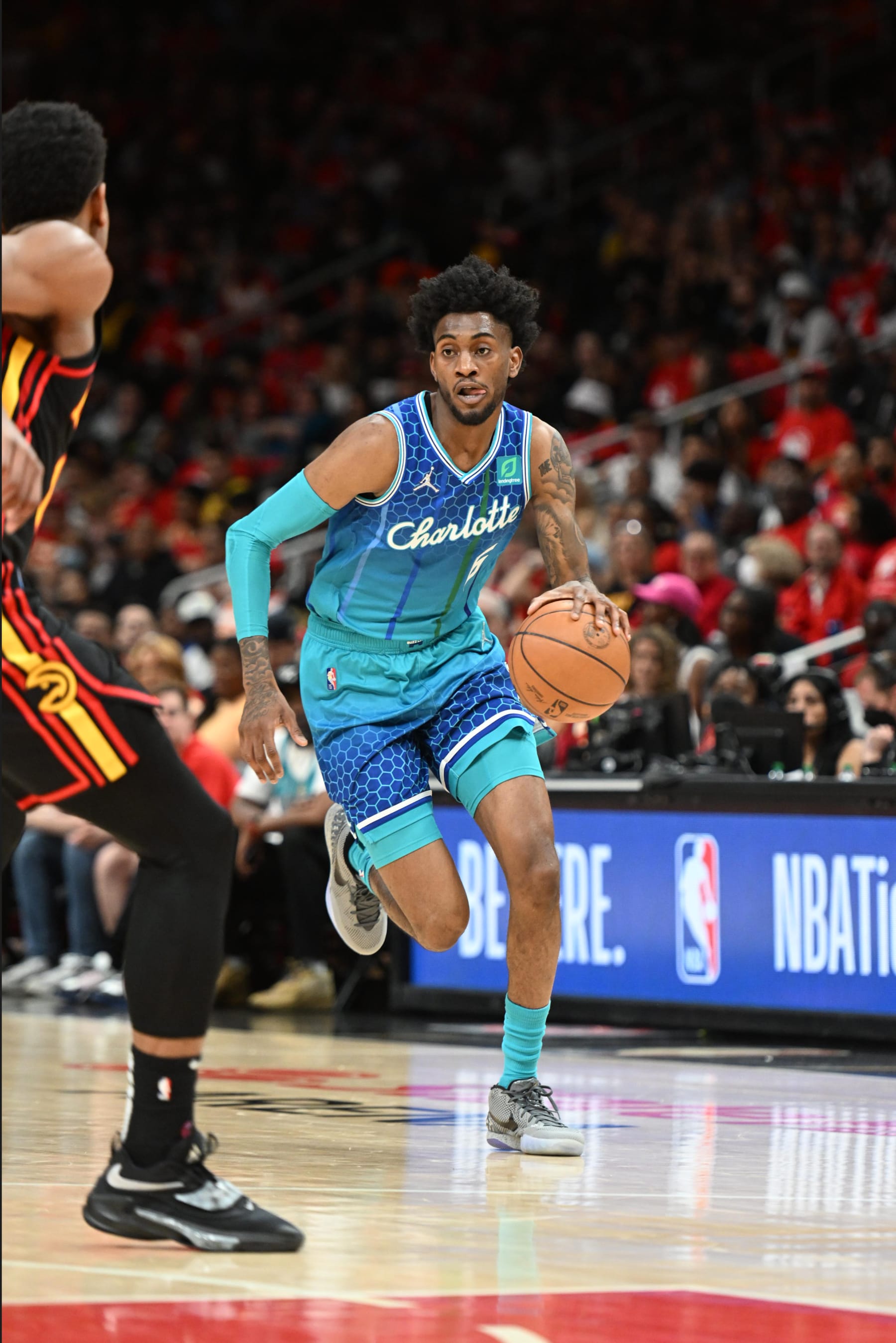ATLANTA, GA - APRIL 13: Jalen McDaniels #6 of the Charlotte Hornets dribbles the ball against the Atlanta Hawks during the 2022 Play-In Tournament on April 13, 2022 at State Farm Arena in Atlanta, Georgia.  NOTE TO USER: User expressly acknowledges and agrees that, by downloading and/or using this Photograph, user is consenting to the terms and conditions of the Getty Images License Agreement. Mandatory Copyright Notice: Copyright 2022 NBAE (Photo by Adam Hagy/NBAE via Getty Images)