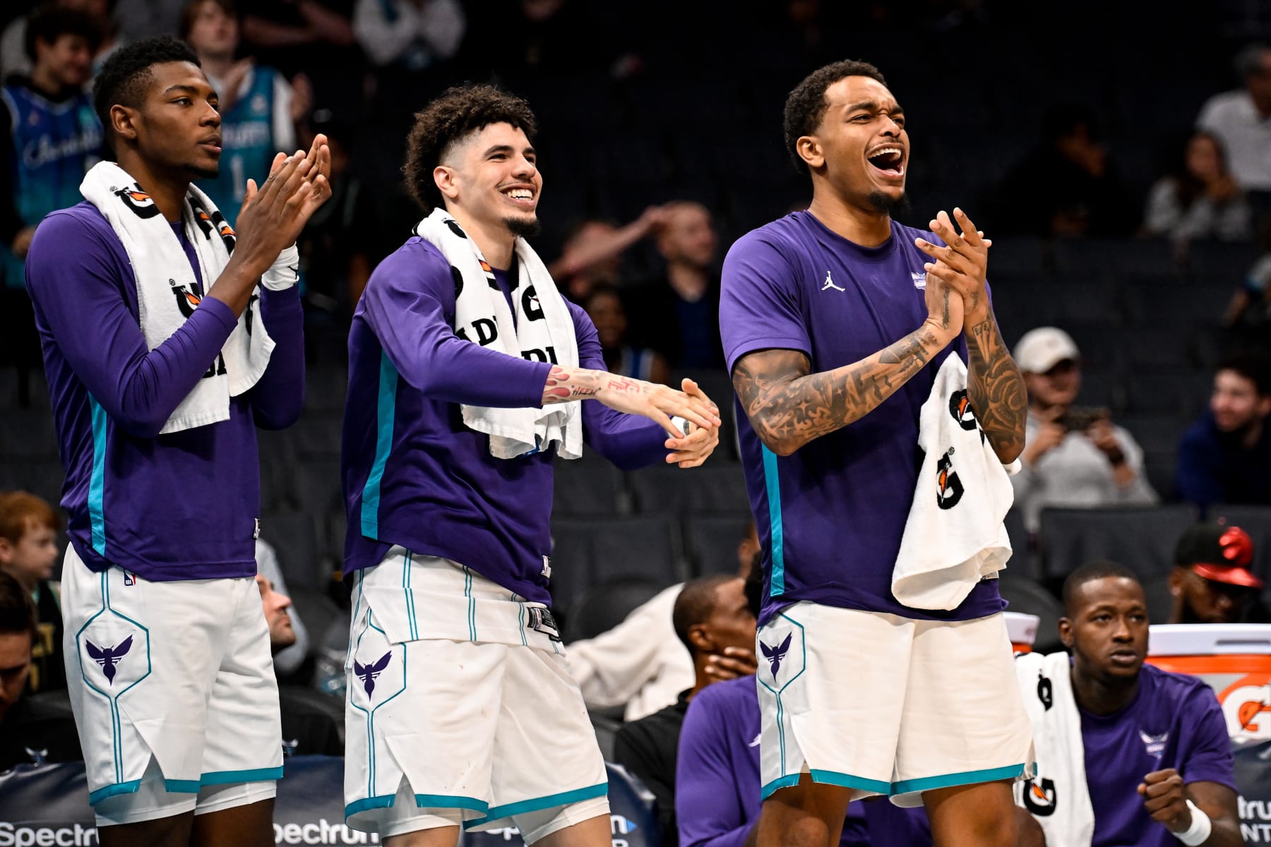CHARLOTTE, NORTH CAROLINA - OCTOBER 15: (L-R) Brandon Miller #24, LaMelo Ball #1, and P.J. Washington #25 of the Charlotte Hornets cheer during the second half of their game against the Oklahoma City Thunder2 at Spectrum Center on October 15, 2023 in Charlotte, North Carolina. NOTE TO USER: User expressly acknowledges and agrees that, by downloading and or using this photograph, User is consenting to the terms and conditions of the Getty Images License Agreement.  (Photo by Matt Kelley/Getty Images)