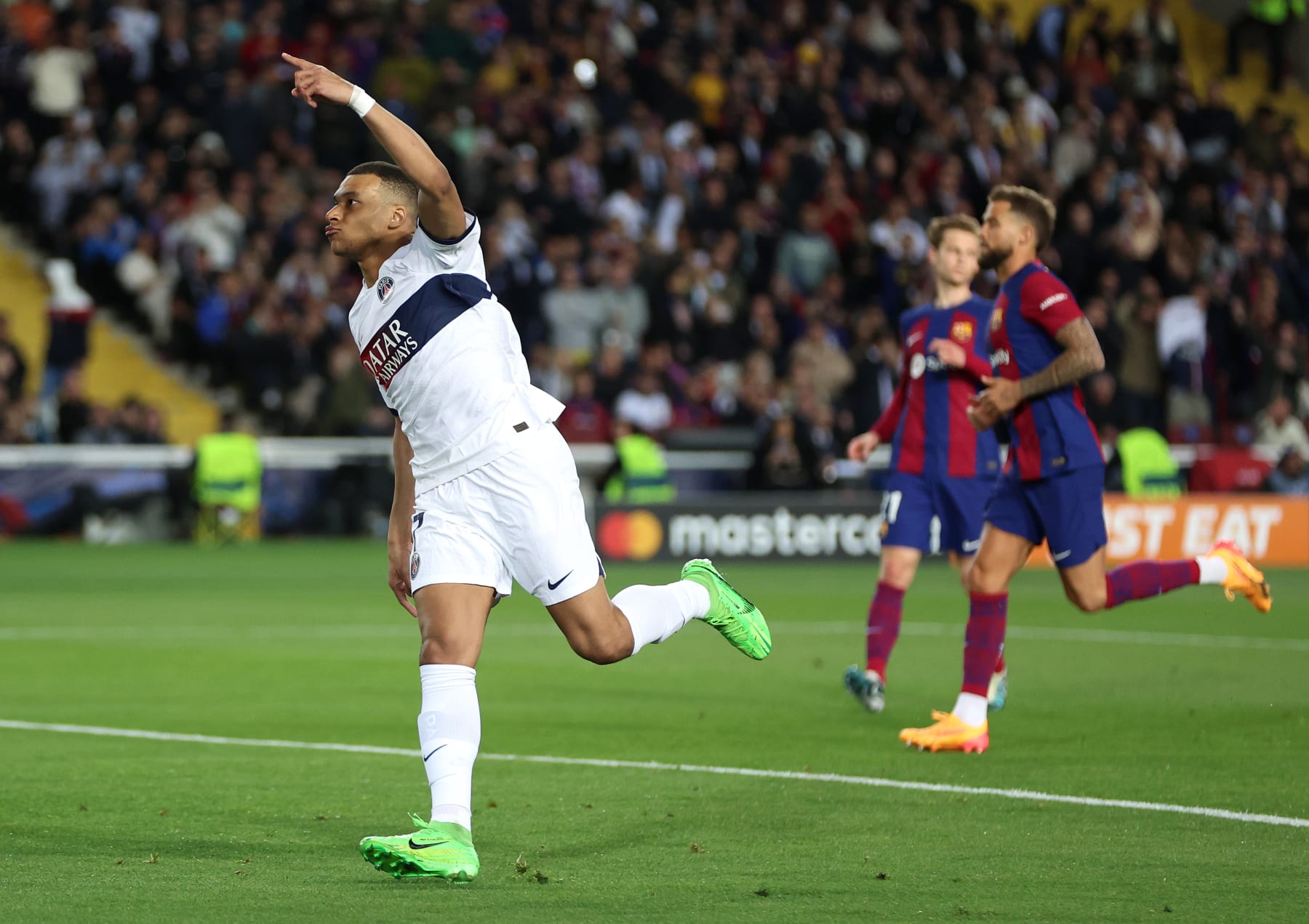 BARCELONA, SPAIN - APRIL 16: Kylian Mbappe of Paris Saint-Germain celebrates scoring his team's third goal from a penalty kick during the UEFA Champions League quarter-final second leg match between FC Barcelona and Paris Saint-Germain at Estadi Olimpic Lluis Companys on April 16, 2024 in Barcelona, Spain. (Photo by Clive Brunskill/Getty Images)