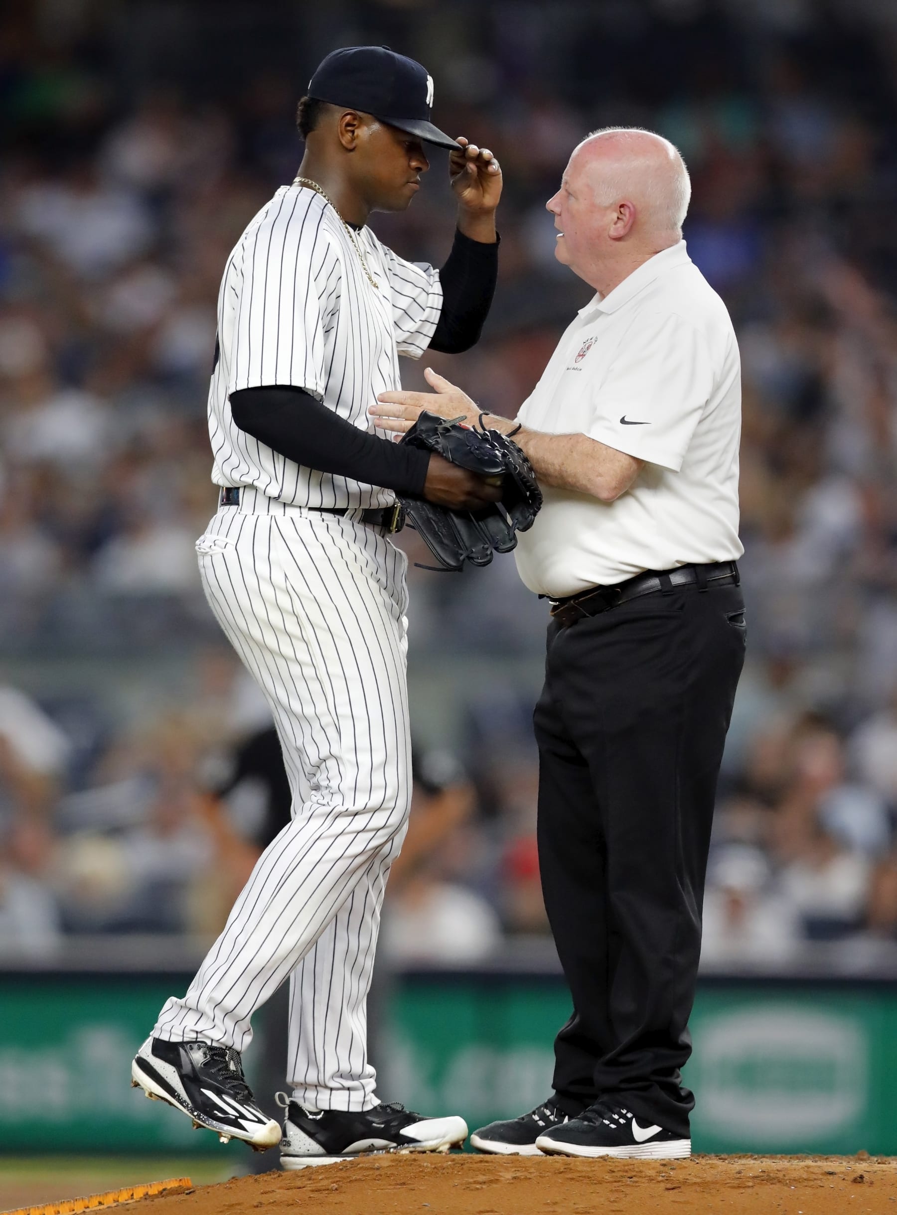 NEW YORK, NY - MAY 25:  Trainer Steve Donahue and pitcher Luis Severino #40 of the New York Yankees talks on the mound in an MLB baseball game against the Oakland Angels on May 25, 2018 at Yankee Stadium in the Bronx borough of New York City. Yankees won 2-1. (Photo by Paul Bereswill/Getty Images)