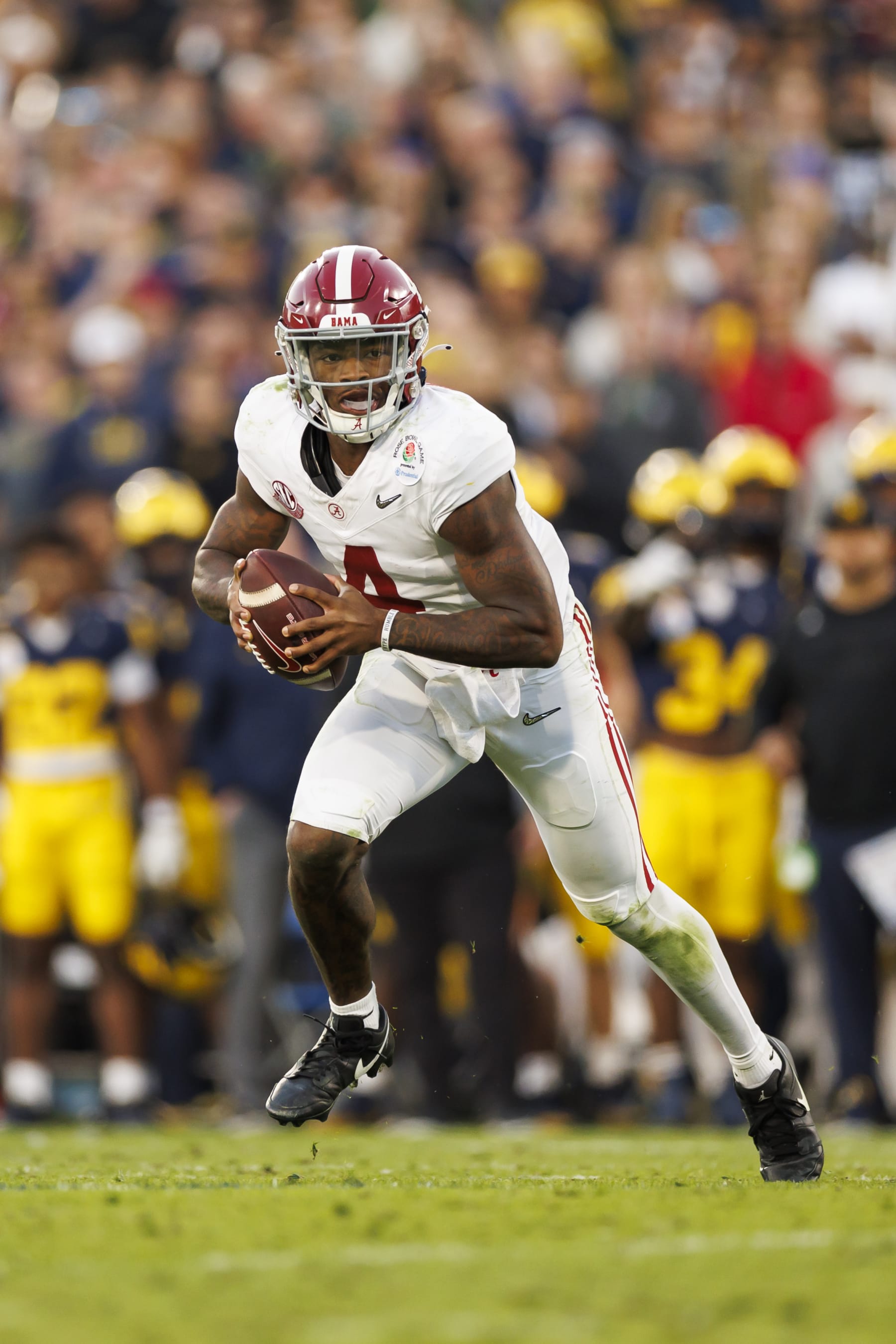 PASADENA, CALIFORNIA - JANUARY 01: Quarterback Jalen Milroe #4 of the Alabama Crimson Tide runs the ball as he scrambles during the CFP Semifinal Rose Bowl Game against the Michigan Wolverines at Rose Bowl Stadium on January 1, 2024 in Pasadena, California. (Photo by Ryan Kang/Getty Images)