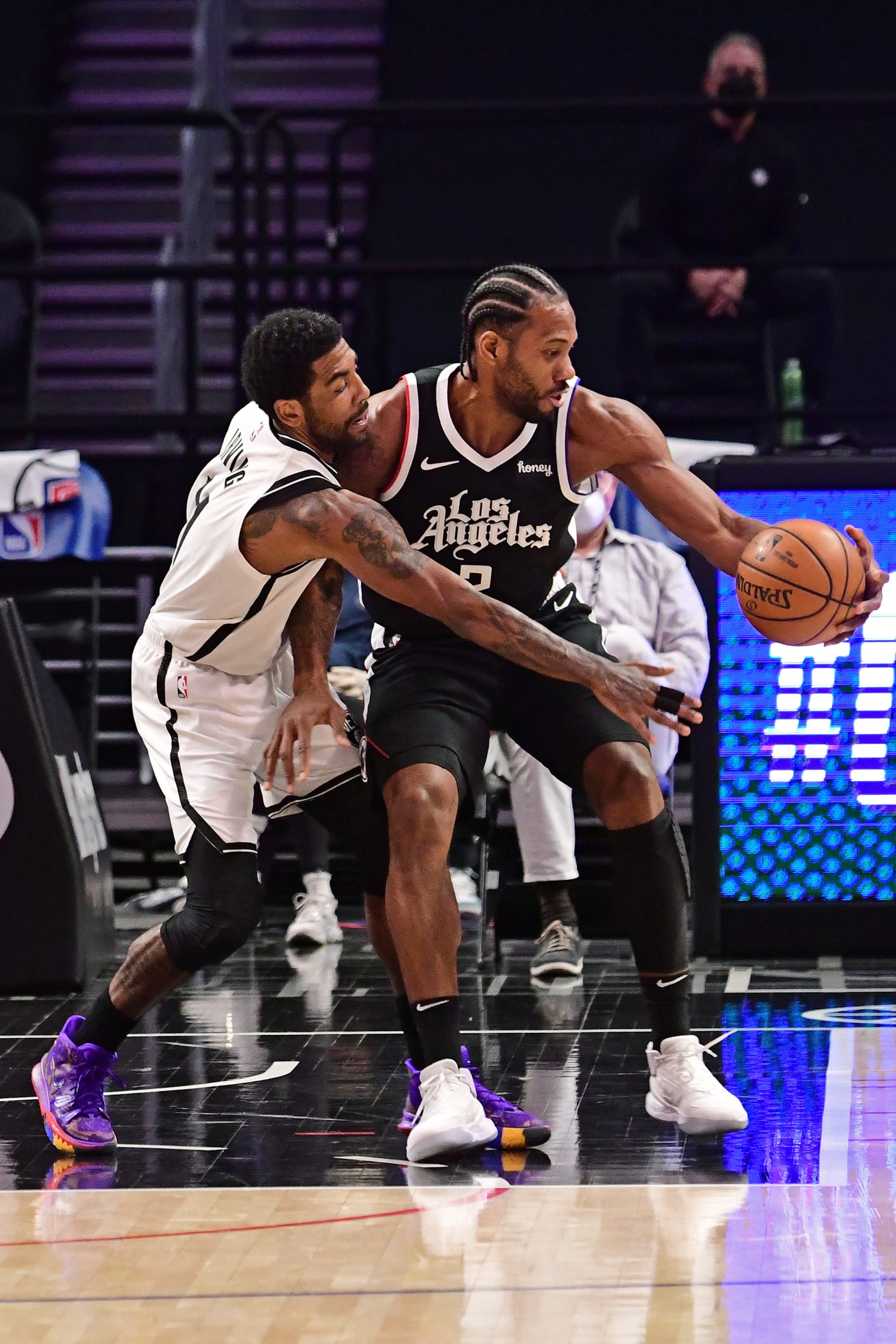 LOS ANGELES, CA  -  FEBRUARY 21: Kyrie Irving #11 of the Brooklyn Nets plays defense as Kawhi Leonard #2 of the LA Clippers dribbles during the game on February 21, 2021 at STAPLES Center in Los Angeles, California. NOTE TO USER: User expressly acknowledges and agrees that, by downloading and/or using this Photograph, user is consenting to the terms and conditions of the Getty Images License Agreement. Mandatory Copyright Notice: Copyright 2021 NBAE (Photo by Adam Pantozzi/NBAE via Getty Images)