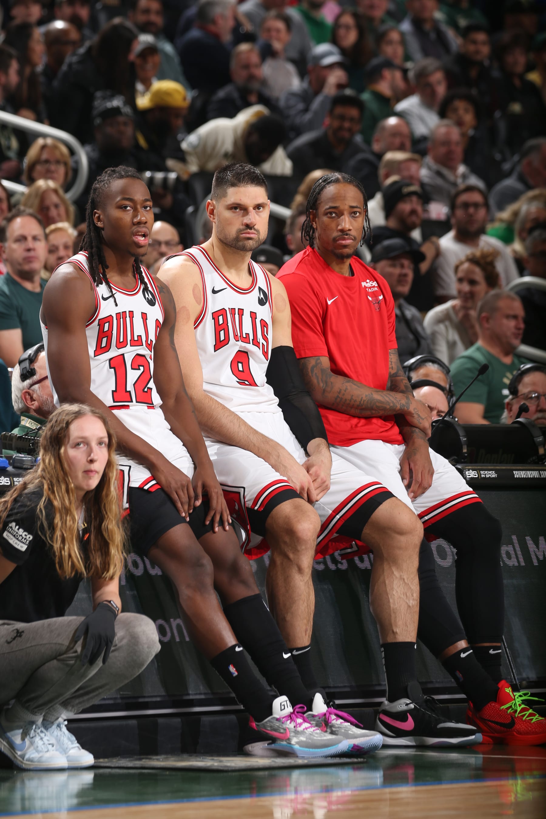 MILWAUKEE, WI - DECEMBER 11:  Ayo Dosunmu #12 of the Chicago Bulls Nikola Vucevic #9 of the Chicago Bulls & DeMar DeRozan #11 of the Chicago Bulls looks on during the game on December 11, 2023 at the Fiserv Forum Center in Milwaukee, Wisconsin. NOTE TO USER: User expressly acknowledges and agrees that, by downloading and or using this Photograph, user is consenting to the terms and conditions of the Getty Images License Agreement. Mandatory Copyright Notice: Copyright 2023 NBAE (Photo by Gary Dineen/NBAE via Getty Images).