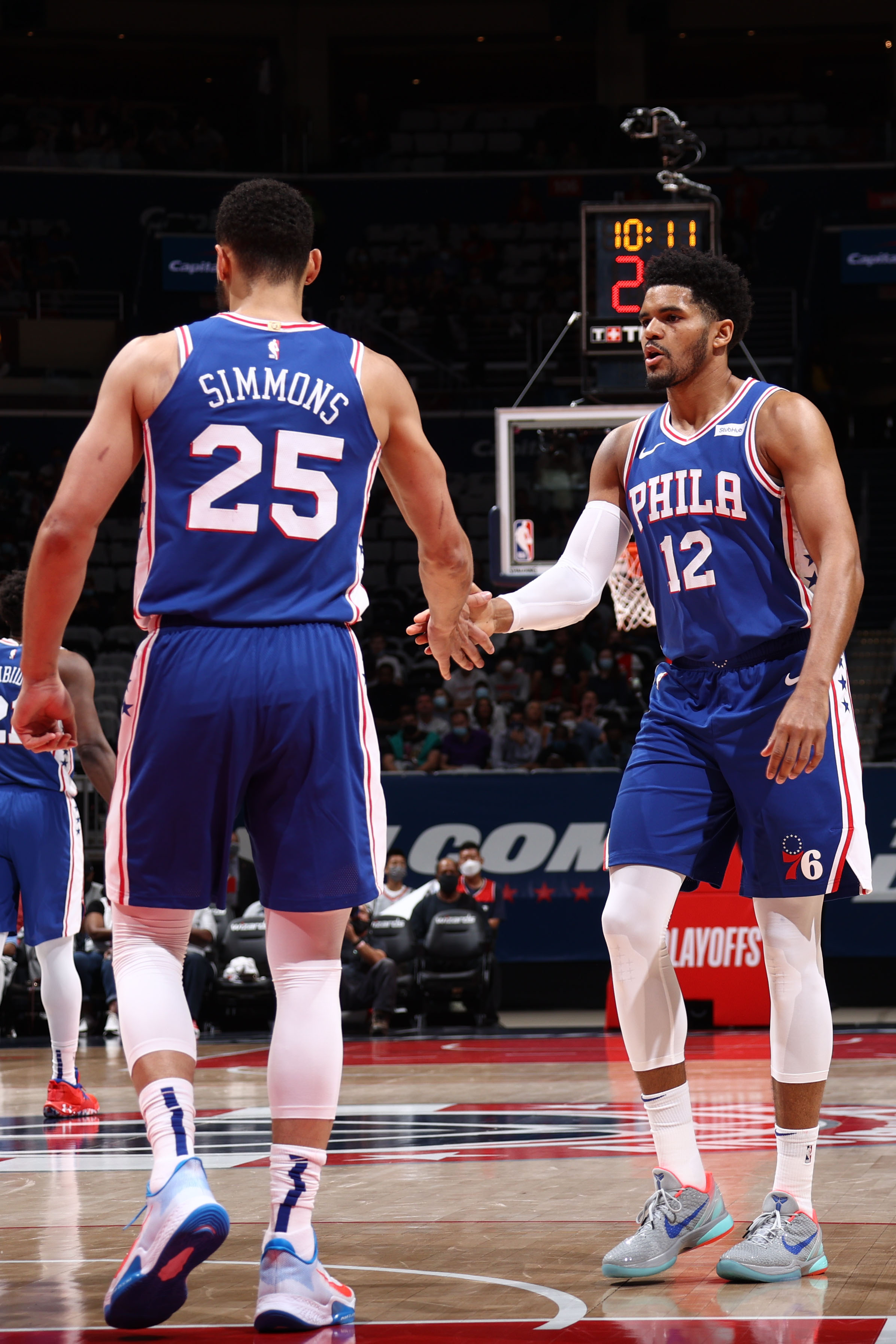 WASHINGTON, DC -  MAY 31: Tobias Harris #12 hi-fives Ben Simmons #25 of the Philadelphia 76ers during the game against the Washington Wizards during Round 1, Game 4 of the 2021 NBA Playoffs on May 31, 2021 at Capital One Arena in Washington, DC. NOTE TO USER: User expressly acknowledges and agrees that, by downloading and or using this Photograph, user is consenting to the terms and conditions of the Getty Images License Agreement. Mandatory Copyright Notice: Copyright 2021 NBAE (Photo by Stephen Gosling/NBAE via Getty Images)