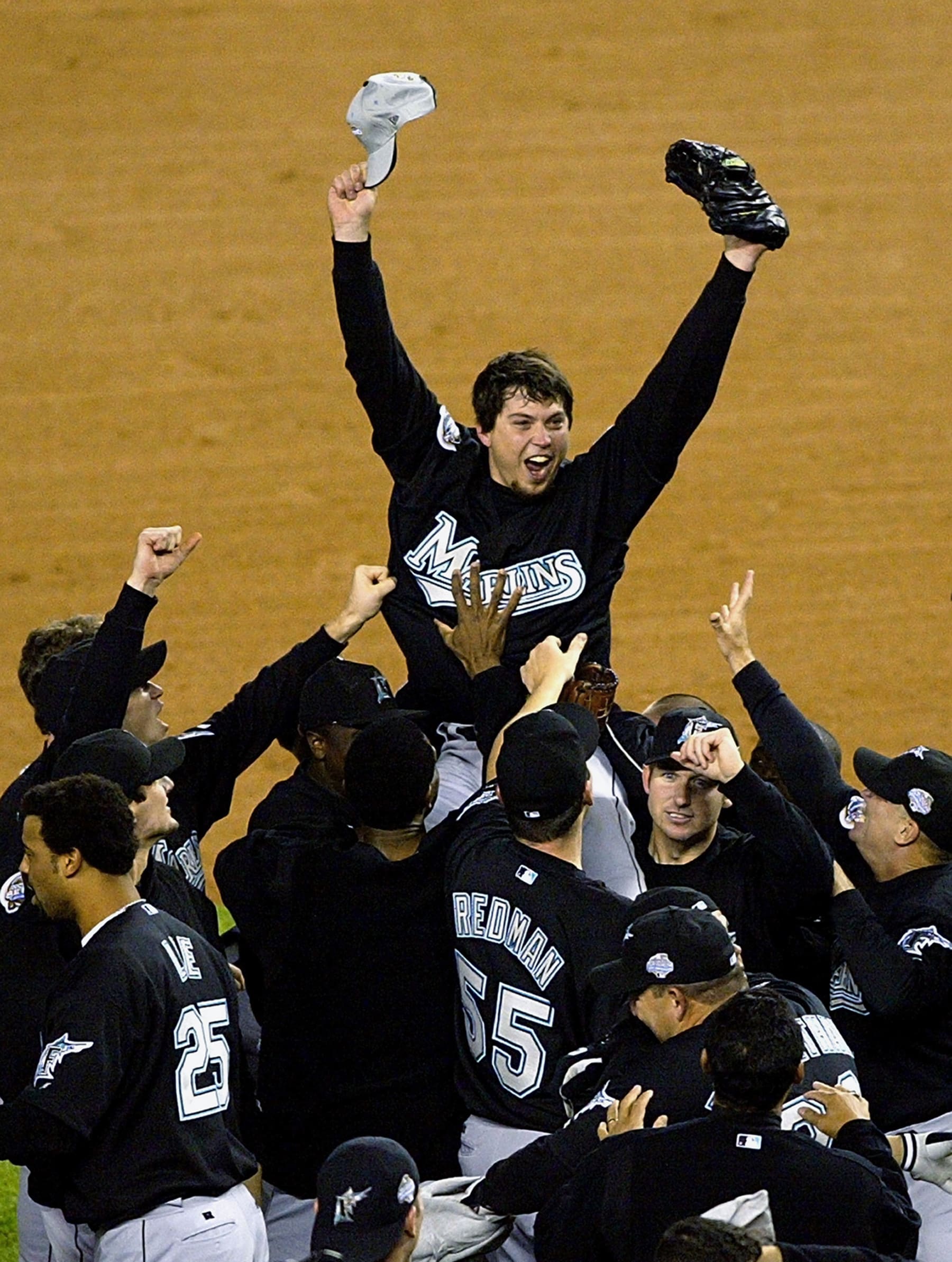 RONX, NY - OCTOBER 25:  The Florida Marlins hoist up pitcher Josh Beckett #21 the 2003 World Series MVP after defeating the New York Yankees 2-0 in game six of the Major League Baseball World Series on October 25, 2003 at Yankee Stadium in the Bronx, New York. Beckett pitched a complete game shut-out in clinch the series for the Marlins.  (Photo by Jamie Squire/Getty Images) 