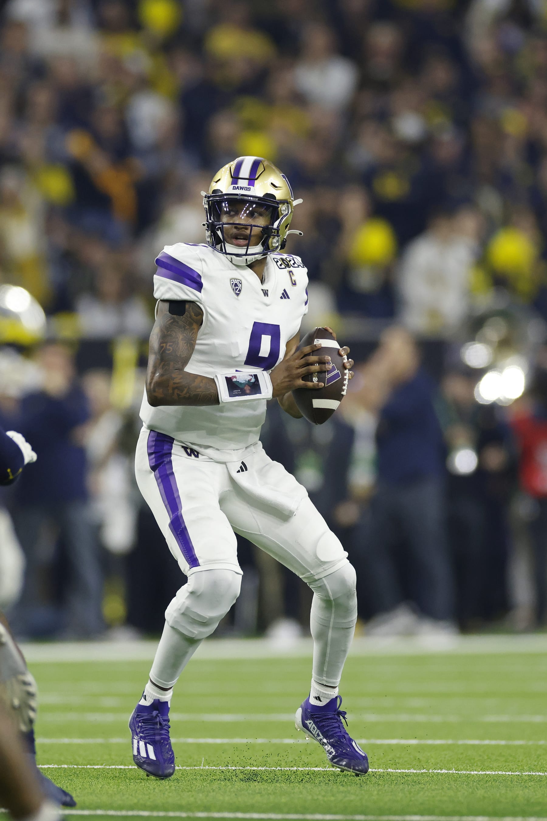 HOUSTON, TX - JANUARY 08: Washington Huskies quarterback Michael Penix Jr. (9) drops back to pass during the CFP National Championship against the Michigan Wolverines on January 08, 2024 at NRG Stadium in Houston, Texas. (Photo by Joe Robbins/Icon Sportswire via Getty Images)