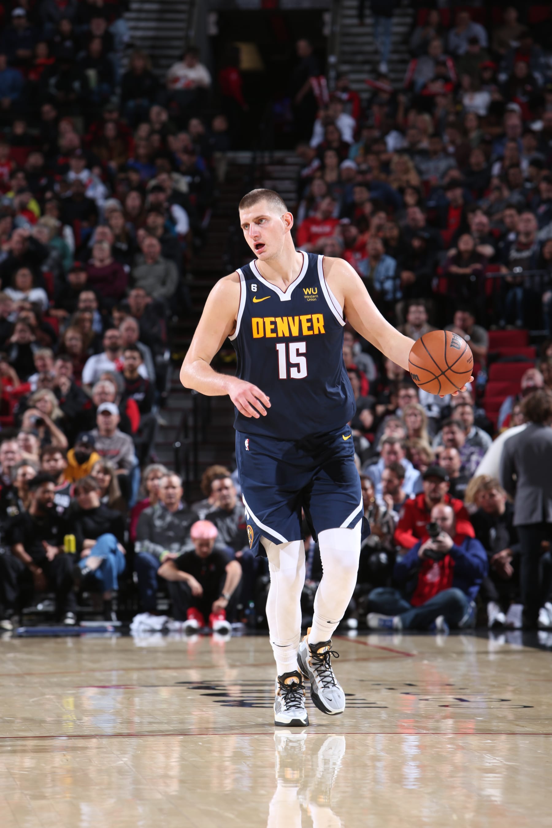 PORTLAND, OR - OCTOBER 24: Nikola Jokic #15 of the Denver Nuggets dribbles the ball during the game against the Portland Trail Blazers on October 24, 2022 at the Moda Center Arena in Portland, Oregon. NOTE TO USER: User expressly acknowledges and agrees that, by downloading and or using this photograph, user is consenting to the terms and conditions of the Getty Images License Agreement. Mandatory Copyright Notice: Copyright 2022 NBAE (Photo by Sam Forencich/NBAE via Getty Images)