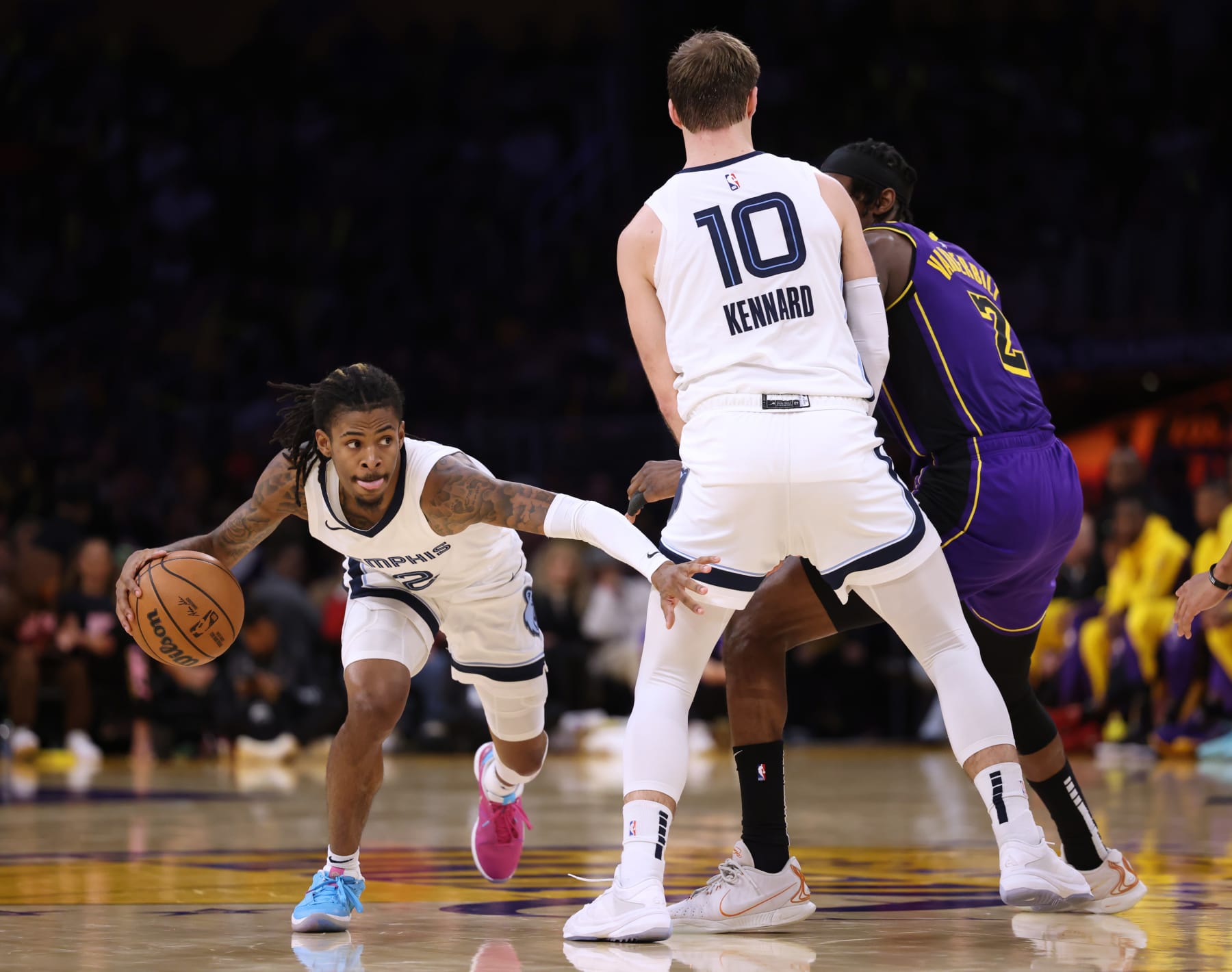 LOS ANGELES, CALIFORNIA - JANUARY 05: Ja Morant #12 of the Memphis Grizzlies dribbles away from a screen set by Luke Kennard #10 on Jarred Vanderbilt #2 of the Los Angeles Lakers during a 127-113 Grizzlies win over the Los Angeles Lakers at Crypto.com Arena on January 05, 2024 in Los Angeles, California. User is consenting to the terms and conditions of the Getty Images License Agreement. (Photo by Harry How/Getty Images)