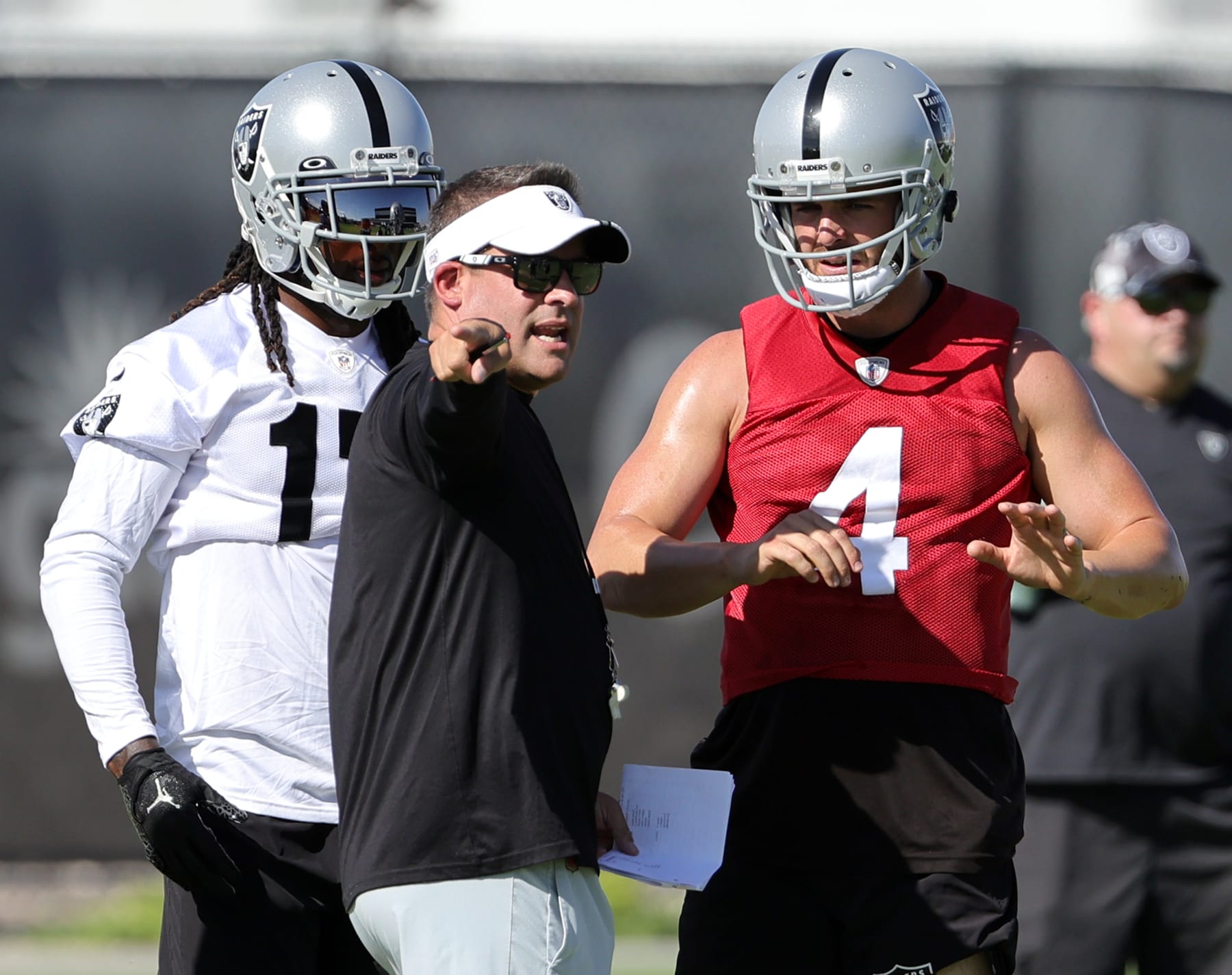 HENDERSON, NEVADA - JULY 24: Wide receiver Davante Adams #17, head coach Josh McDaniels and quarterback Derek Carr #4 of the Las Vegas Raiders talk during training camp at the Las Vegas Raiders Headquarters/Intermountain Healthcare Performance Center on July 24, 2022 in Henderson, Nevada. (Photo by Ethan Miller/Getty Images)