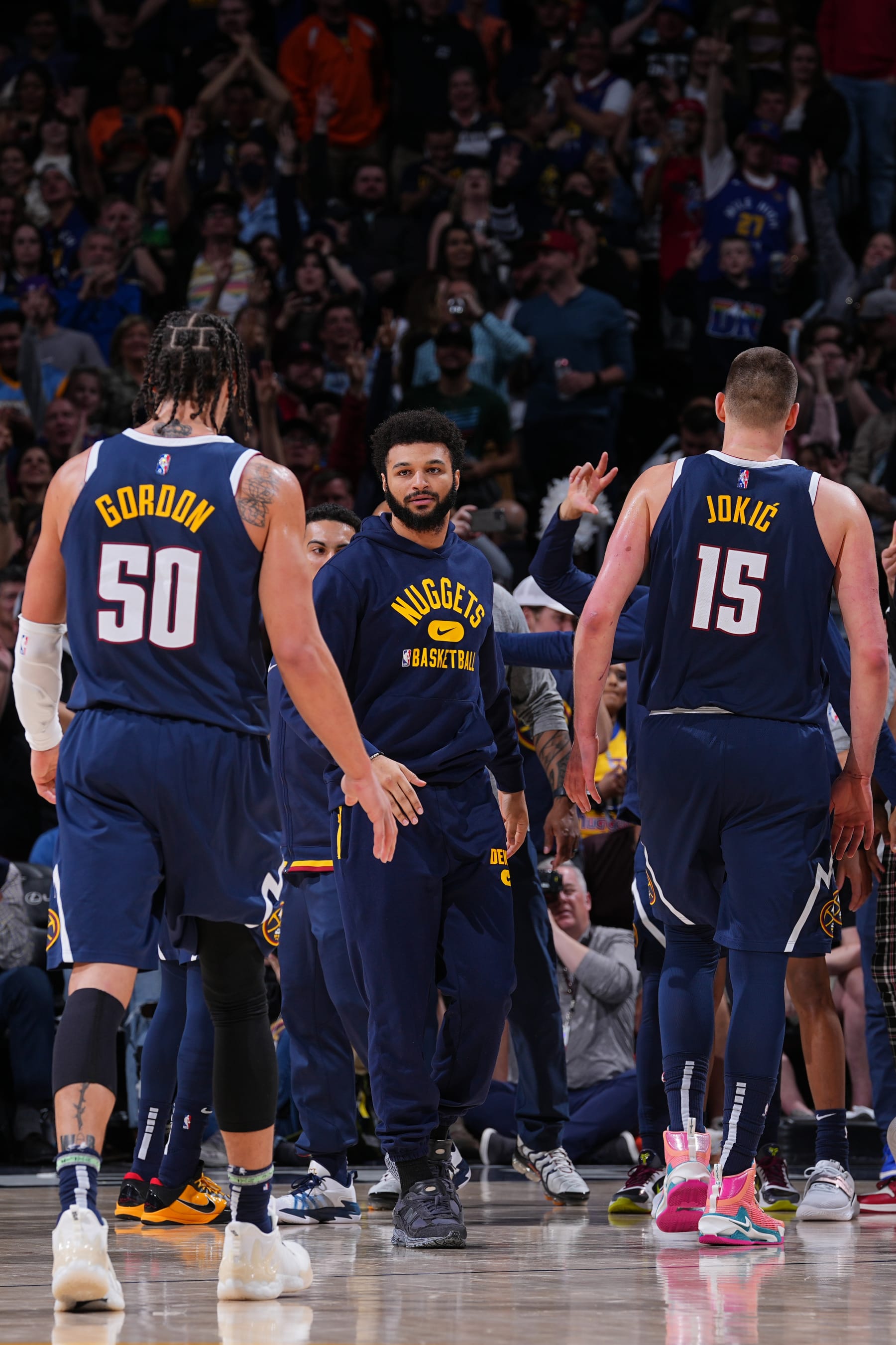 DENVER, CO - MARCH 26: Jamal Murray #27 high fives Nikola Jokic #15 and Aaron Gordon #50 of the Denver Nuggets during the game against the Oklahoma City Thunder on March 26, 2022 at the Ball Arena in Denver, Colorado. NOTE TO USER: User expressly acknowledges and agrees that, by downloading and/or using this Photograph, user is consenting to the terms and conditions of the Getty Images License Agreement. Mandatory Copyright Notice: Copyright 2022 NBAE (Photo by Bart Young/NBAE via Getty Images)
