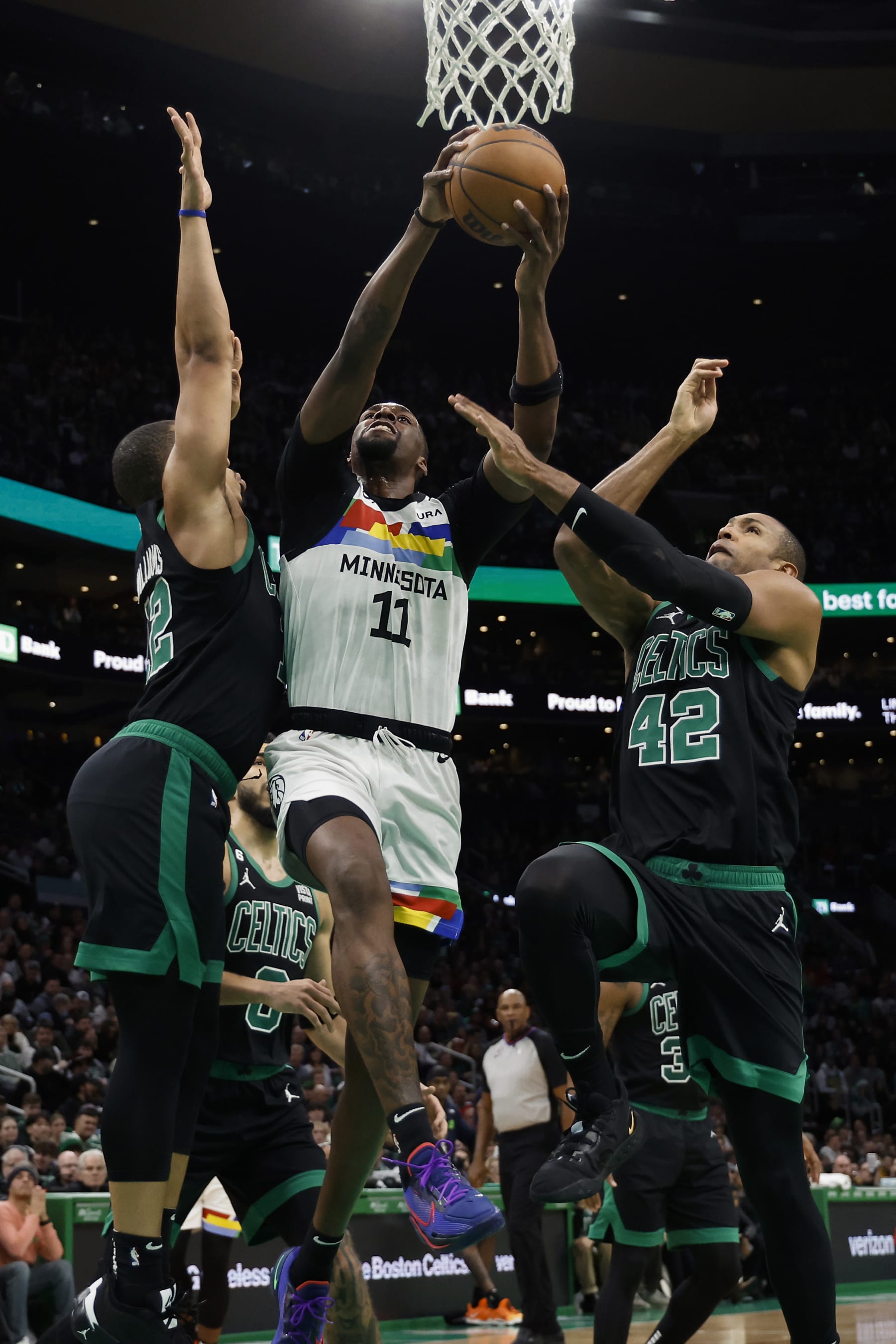 BOSTON, MA - DECEMBER 23: Naz Reid #11 of the Minnesota Timberwolves goes for a shot between Al Horford #42 of the Boston Celtics and Grant Williams during the second quarter at TD Garden on December 23, 2022 in Boston, Massachusetts. NOTE TO USER: User expressly acknowledges and agrees that, by downloading and/or using this Photograph, user is consenting to the terms and conditions of the Getty Images License Agreement. (Photo By Winslow Townson/Getty Images)