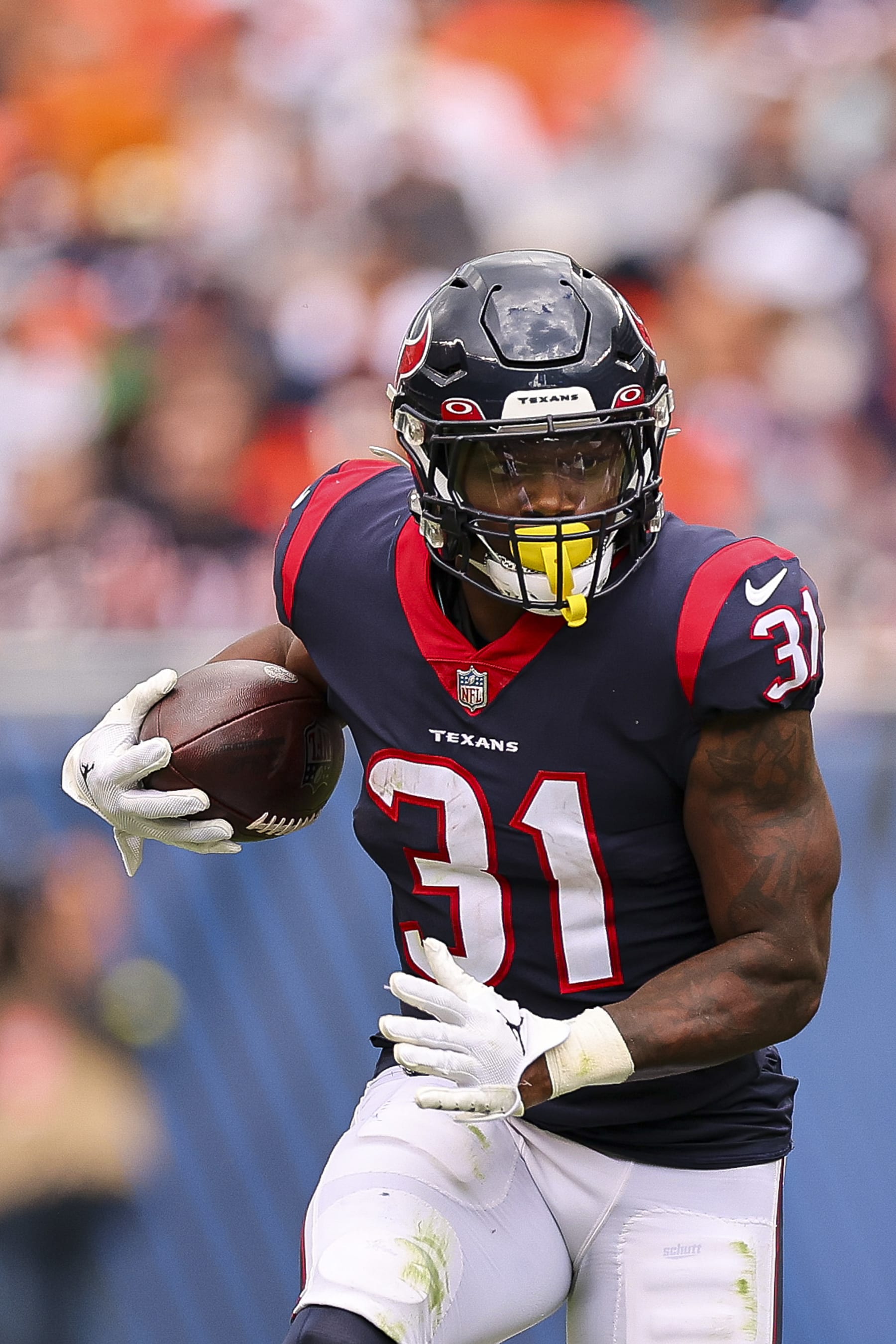CHICAGO, ILLINOIS - SEPTEMBER 25: Running back Dameon Pierce #31 of the Houston Texans runs the ball during the first half against the Chicago Bears at Soldier Field on September 25, 2022 in Chicago, Illinois. (Photo by Michael Reaves/Getty Images)