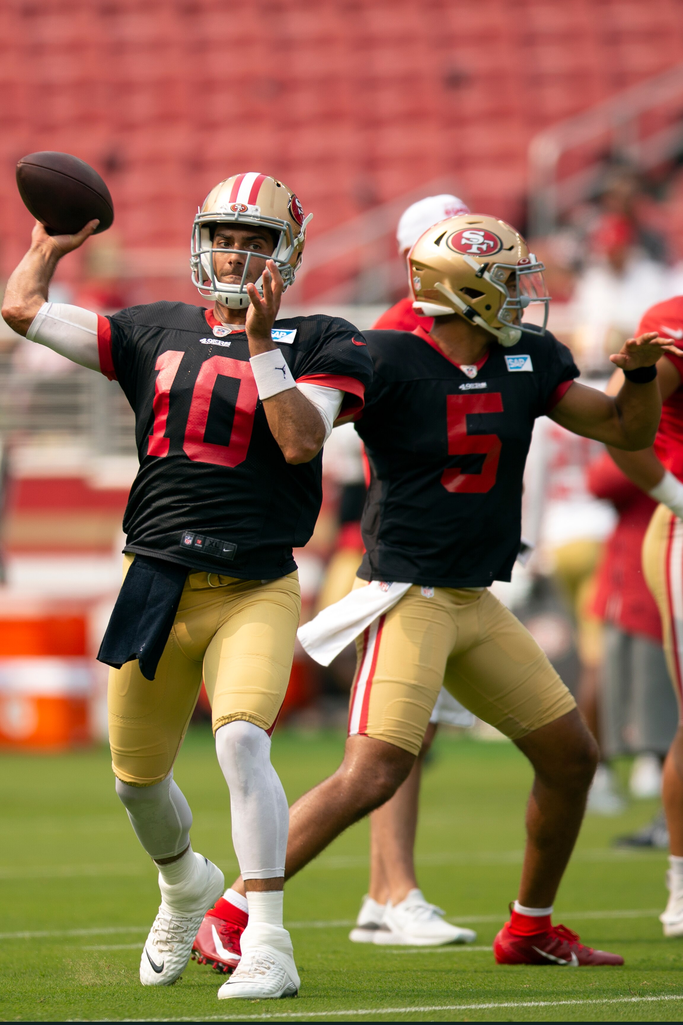San Francisco 49ers quarterbacks Jimmy Garoppolo (10) and Trey Lance (5) work on passing drills during an NFL football open practice, Saturday, Aug. 7, 2021, in Santa Clara, Calif. (AP Photo/D. Ross Cameron)