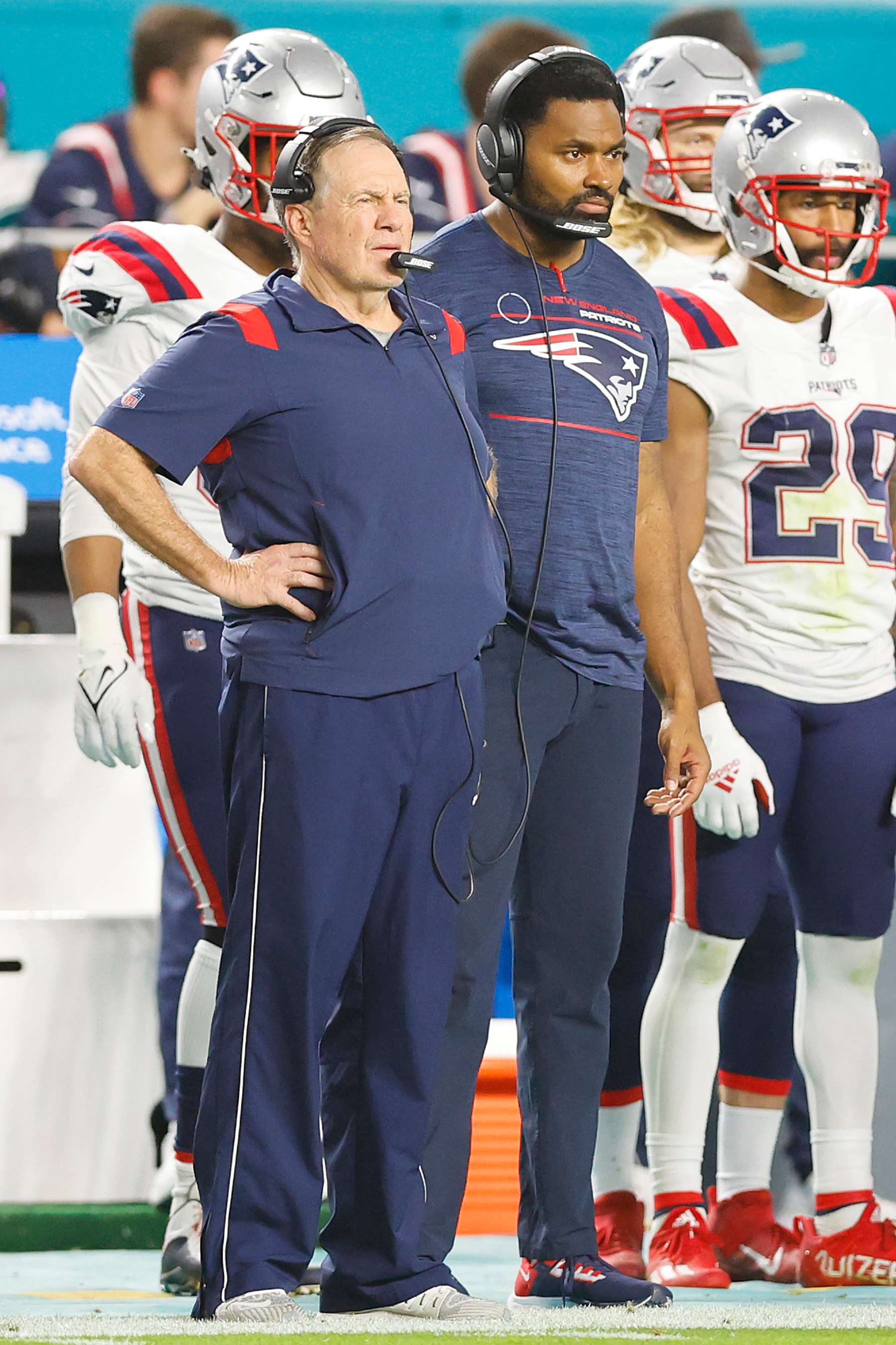 MIAMI GARDENS, FLORIDA - JANUARY 09: Head coach Bill Belichick and outside linebackers coach Jerod Mayo of the New England Patriots look on against the Miami Dolphins during the fourth quarter at Hard Rock Stadium on January 09, 2022 in Miami Gardens, Florida. (Photo by Michael Reaves/Getty Images)