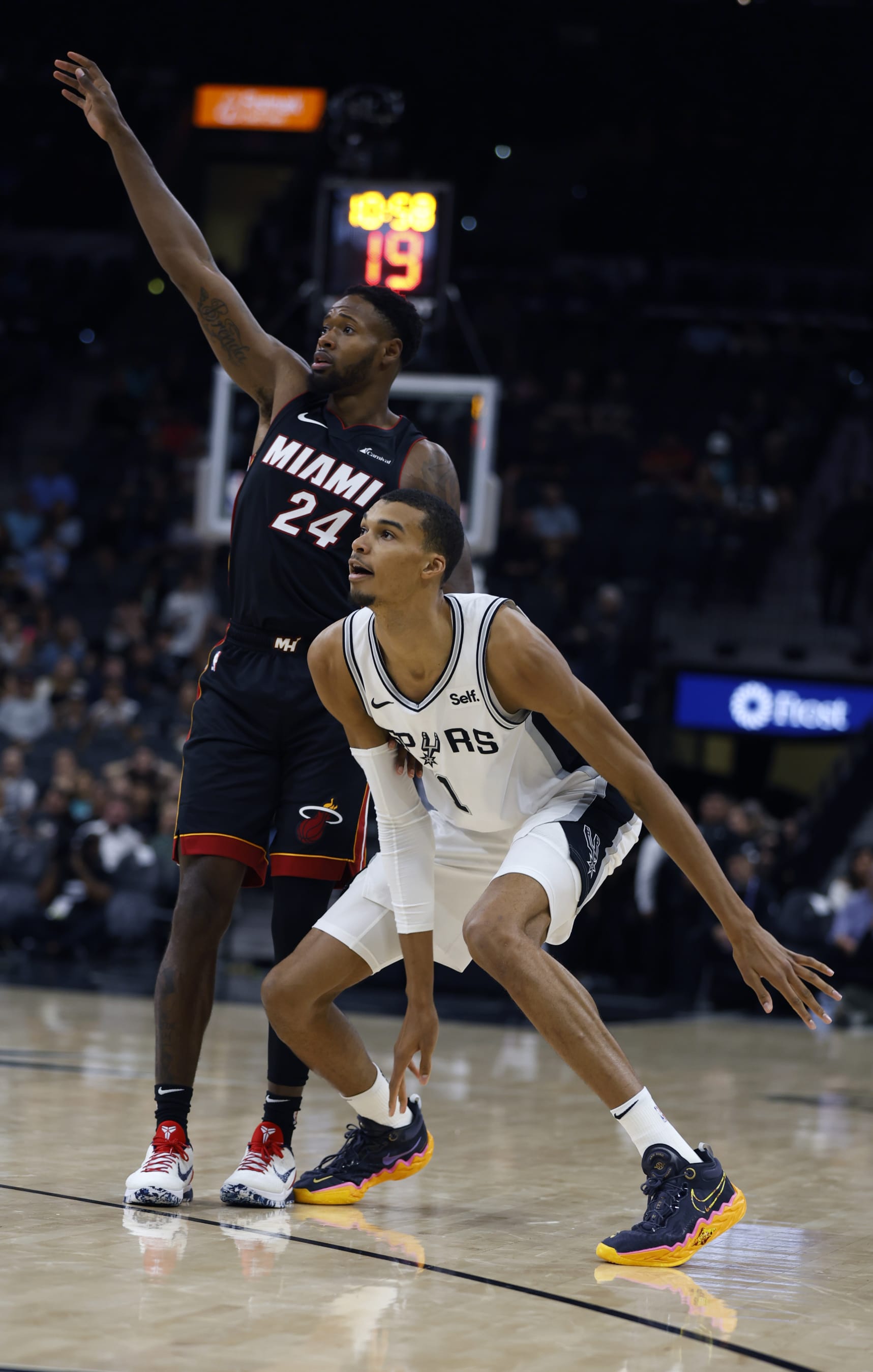 SAN ANTONIO, TX - OCTOBER 13: Victor Wembanyama #1 of the San Antonio Spurs watches three point shot along with Haywood Highsmith #24 of the Miami Heat in a pre-season NBA game at Frost Bank Center on October 13, 2023 in San Antonio, Texas. NOTE TO USER: User expressly acknowledges and agrees that, by downloading and or using this photograph, User is consenting to terms and conditions of the Getty Images License Agreement. (Photo by Ronald Cortes/Getty Images)