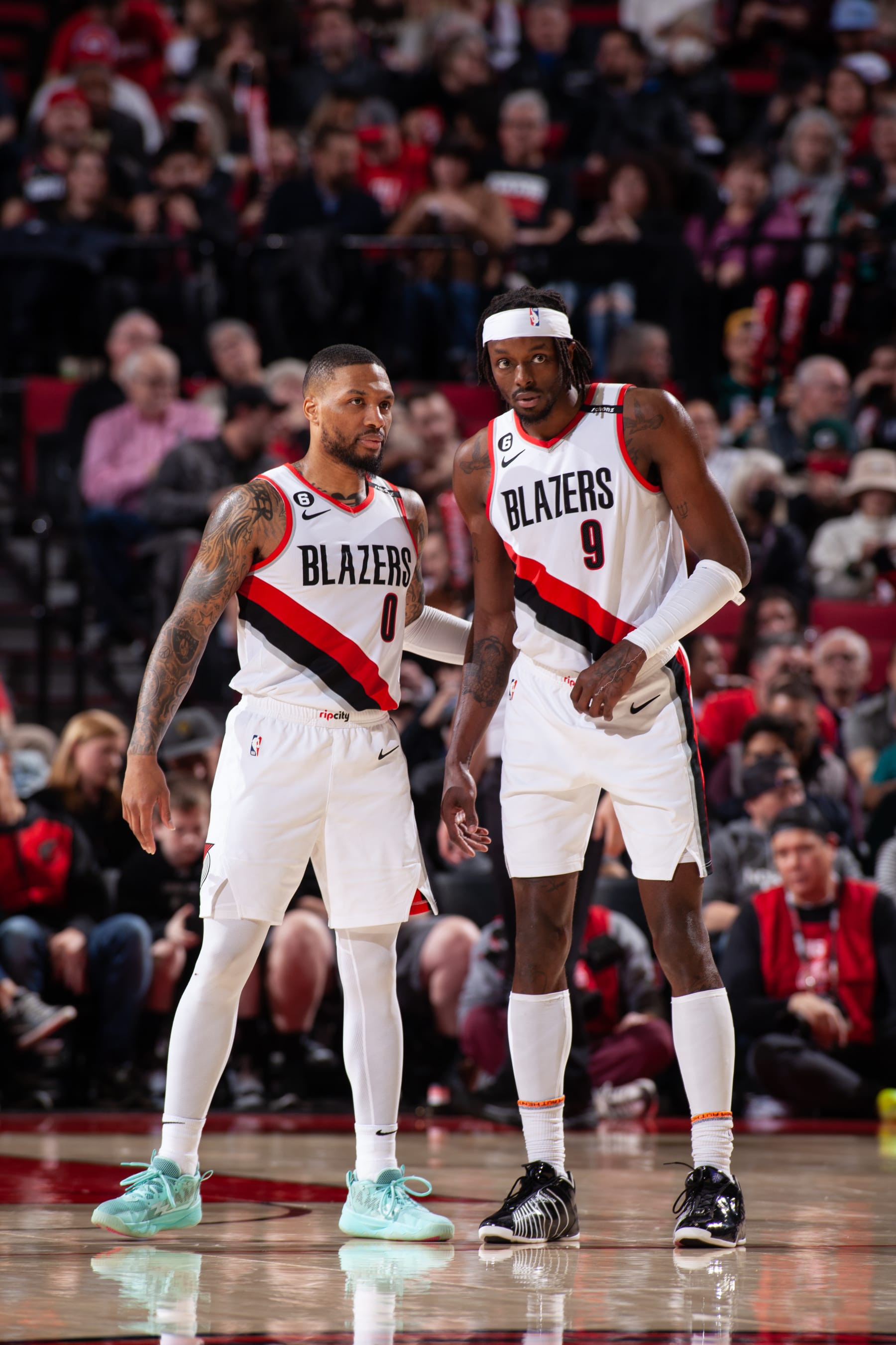 PORTLAND, OR - JANUARY 28:  Damian Lillard #0 and Jerami Grant #9 of the Portland Trail Blazers looks on during the game on January 28, 2023 at the Moda Center Arena in Portland, Oregon. NOTE TO USER: User expressly acknowledges and agrees that, by downloading and or using this photograph, user is consenting to the terms and conditions of the Getty Images License Agreement. Mandatory Copyright Notice: Copyright 2023 NBAE (Photo by Cameron Browne/NBAE via Getty Images)