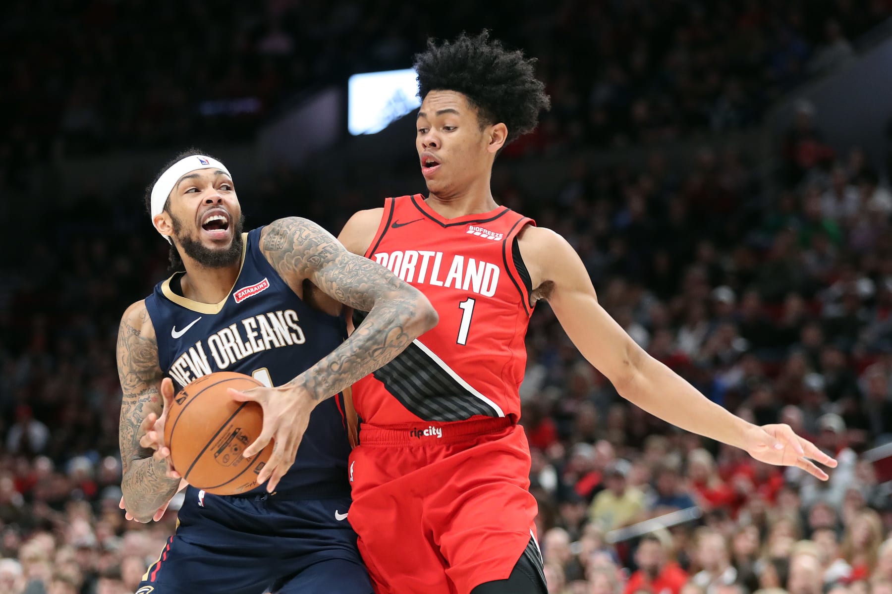 PORTLAND, OREGON - DECEMBER 23: Brandon Ingram #14 of the New Orleans Pelicans dribbles with the ball against Anfernee Simons #1 of the Portland Trail Blazers in the fourth quarter during their game at Moda Center on December 23, 2019 in Portland, Oregon. NOTE TO USER: User expressly acknowledges and agrees that, by downloading and or using this photograph, User is consenting to the terms and conditions of the Getty Images License Agreement (Photo by Abbie Parr/Getty Images) (Photo by Abbie Parr/Getty Images)