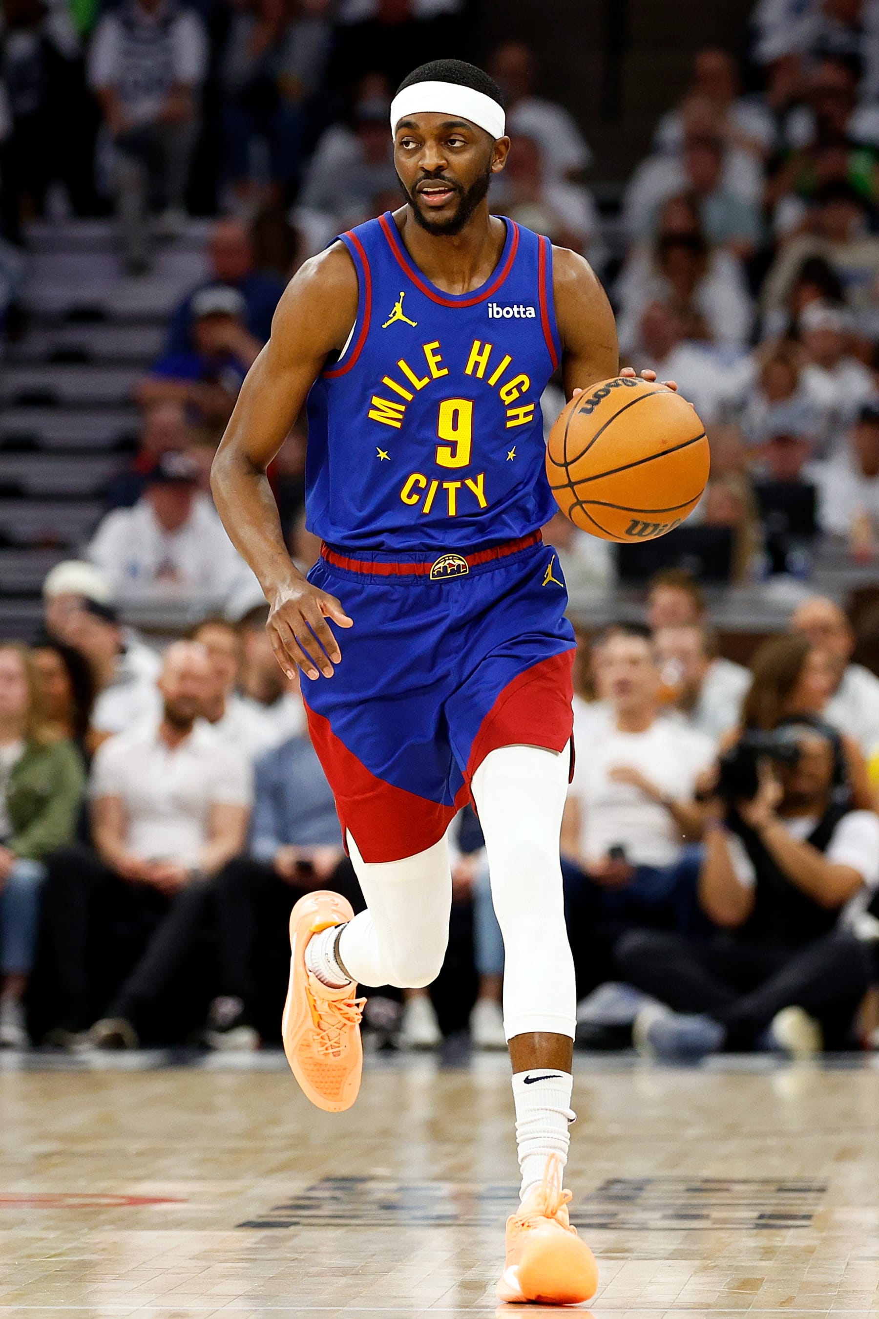MINNEAPOLIS, MINNESOTA - MAY 10: Justin Holiday #9 of the Denver Nuggets dribbles the ball against the Minnesota Timberwolves in the second quarter of Game Three of the Western Conference Second Round Playoffs at Target Center on May 10, 2024 in Minneapolis, Minnesota. The Nuggets defeated the Timberwolves 117-90. (Photo by David Berding/Getty Images) MINNEAPOLIS, MINNESOTA - MAY 10: Justin Holiday #9 of the Denver Nuggets dribbles the ball against the Minnesota Timberwolves in the second quarter of Game Three of the Western Conference Second Round Playoffs at Target Center on May 10, 2024 in Minneapolis, Minnesota. The Nuggets defeated the Timberwolves 117-90. (Photo by David Berding/Getty Images)
