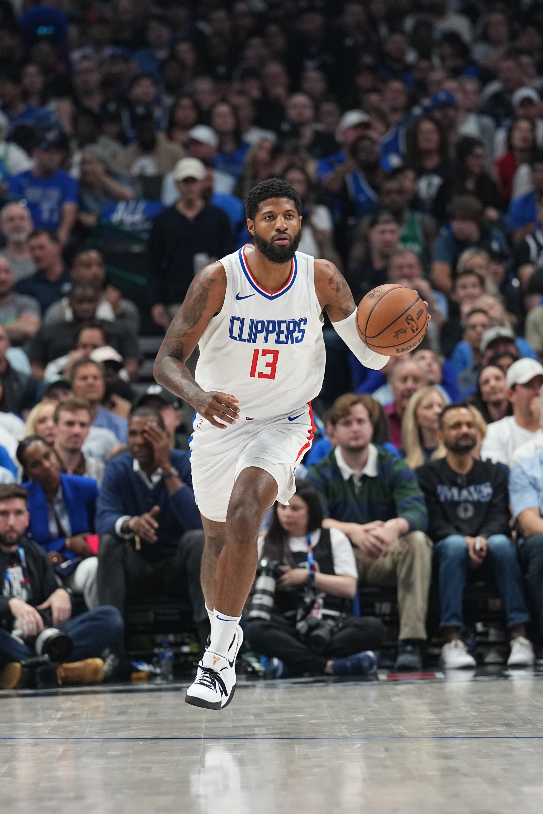 DALLAS, TX - MAY 3:  Paul George #13 of the LA Clippers handles the ball during the game  against the Dallas Mavericks during Round 1 Game 6 of the 2024 NBA Playoffs  on May 3, 2024  at the American Airlines Center in Dallas, Texas. NOTE TO USER: User expressly acknowledges and agrees that, by downloading and or using this photograph, User is consenting to the terms and conditions of the Getty Images License Agreement. Mandatory Copyright Notice: Copyright 2024 NBAE (Photo by Glenn James/NBAE via Getty Images)