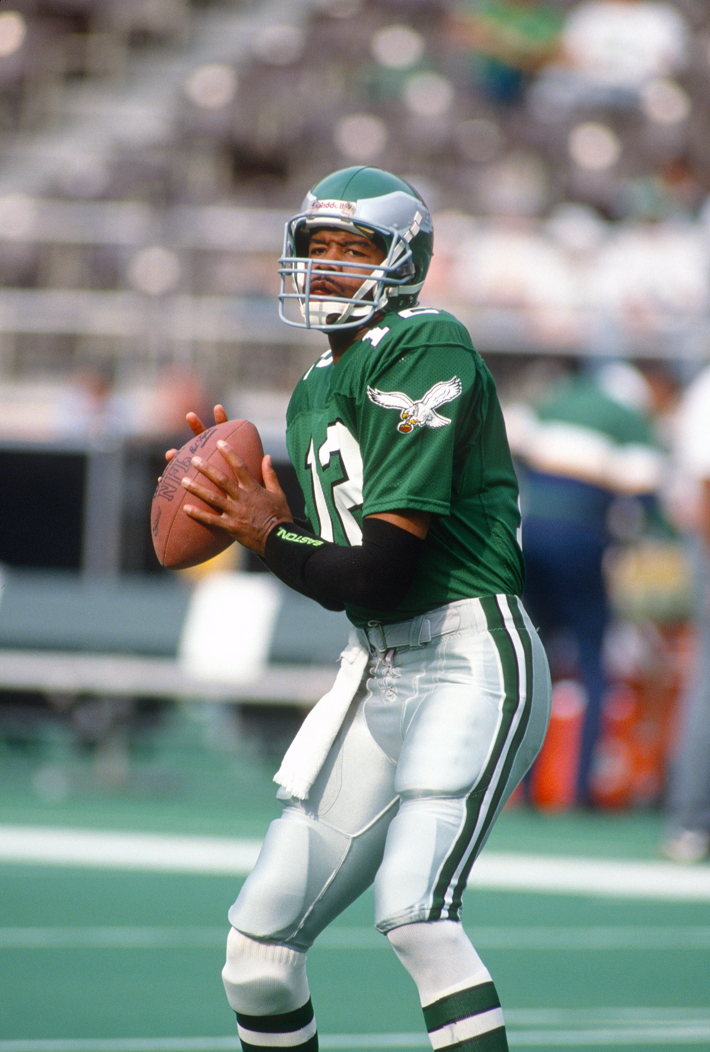PHILADELPHIA, PA - CIRCA 1990:  Randall Cunningham #12 of the Philadelphia Eagles looks to pass during an NFL Football game circa 1990 at Veterans Stadium in Philadelphia, Pennsylvania. Cunningham played for the Eagles from 1985-95. (Photo by Focus on Sport/Getty Images)