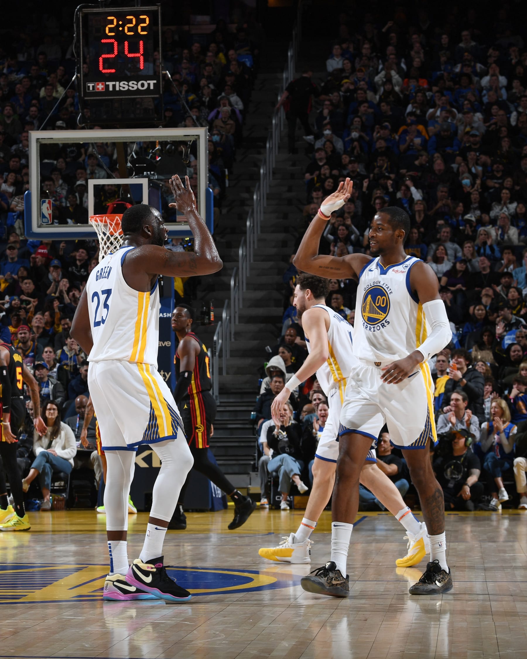 SAN FRANCISCO, CA - JANUARY 24: Draymond Green #23 high fives Jonathan Kuminga #00 of the Golden State Warriors during the game against the Atlanta Hawks on January 24, 2024 at Chase Center in San Francisco, California. NOTE TO USER: User expressly acknowledges and agrees that, by downloading and or using this photograph, user is consenting to the terms and conditions of Getty Images License Agreement. Mandatory Copyright Notice: Copyright 2024 NBAE (Photo by Noah Graham/NBAE via Getty Images)