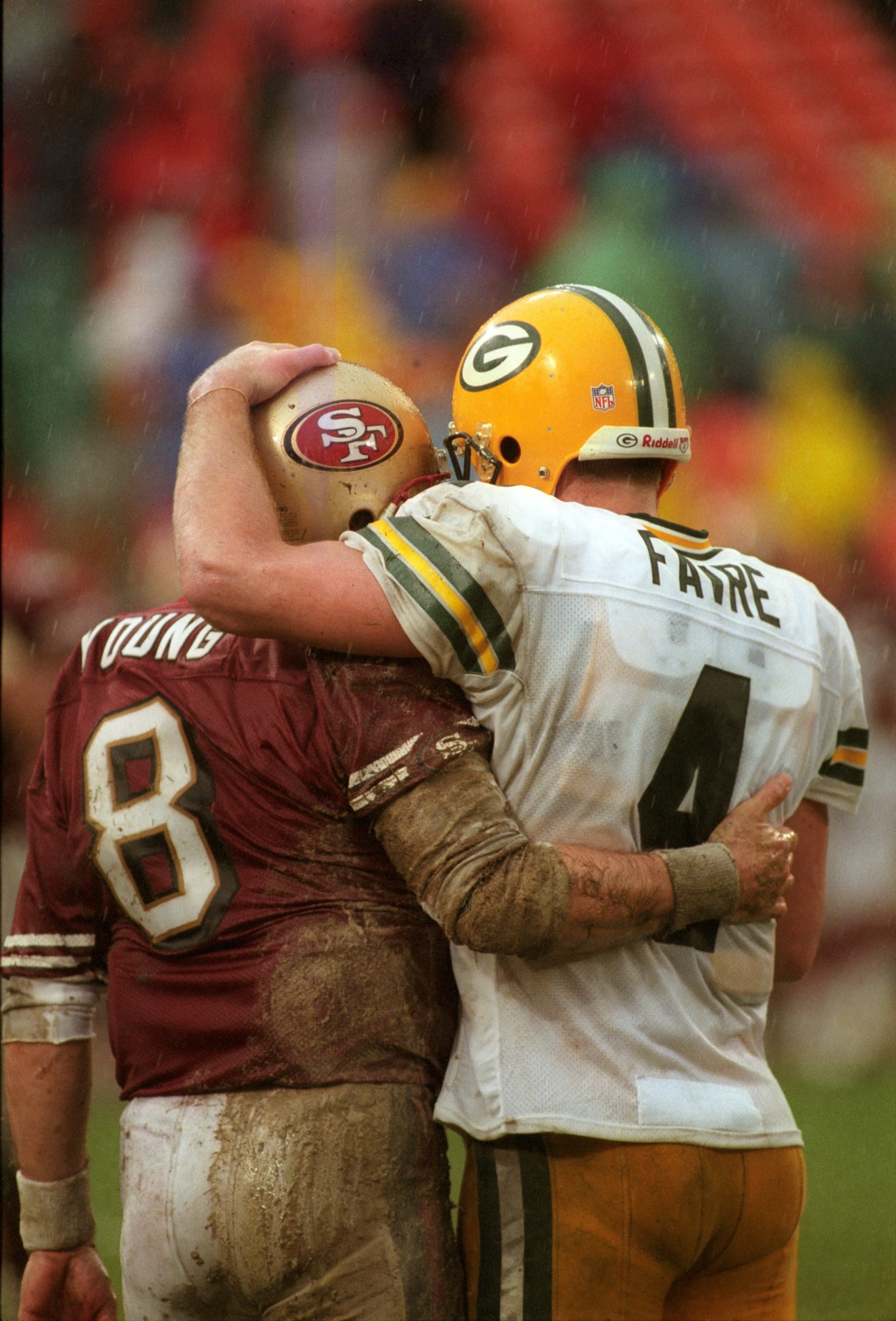 UNITED STATES - JANUARY 11:  Football: NFC playoffs, San Francisco 49ers QB Steve Young embracing Green Bay Packers QB Brett Favre after game with rain, weather, San Francisco, CA 1/11/1998  (Photo by Mickey Pfleger/Sports Illustrated via Getty Images)