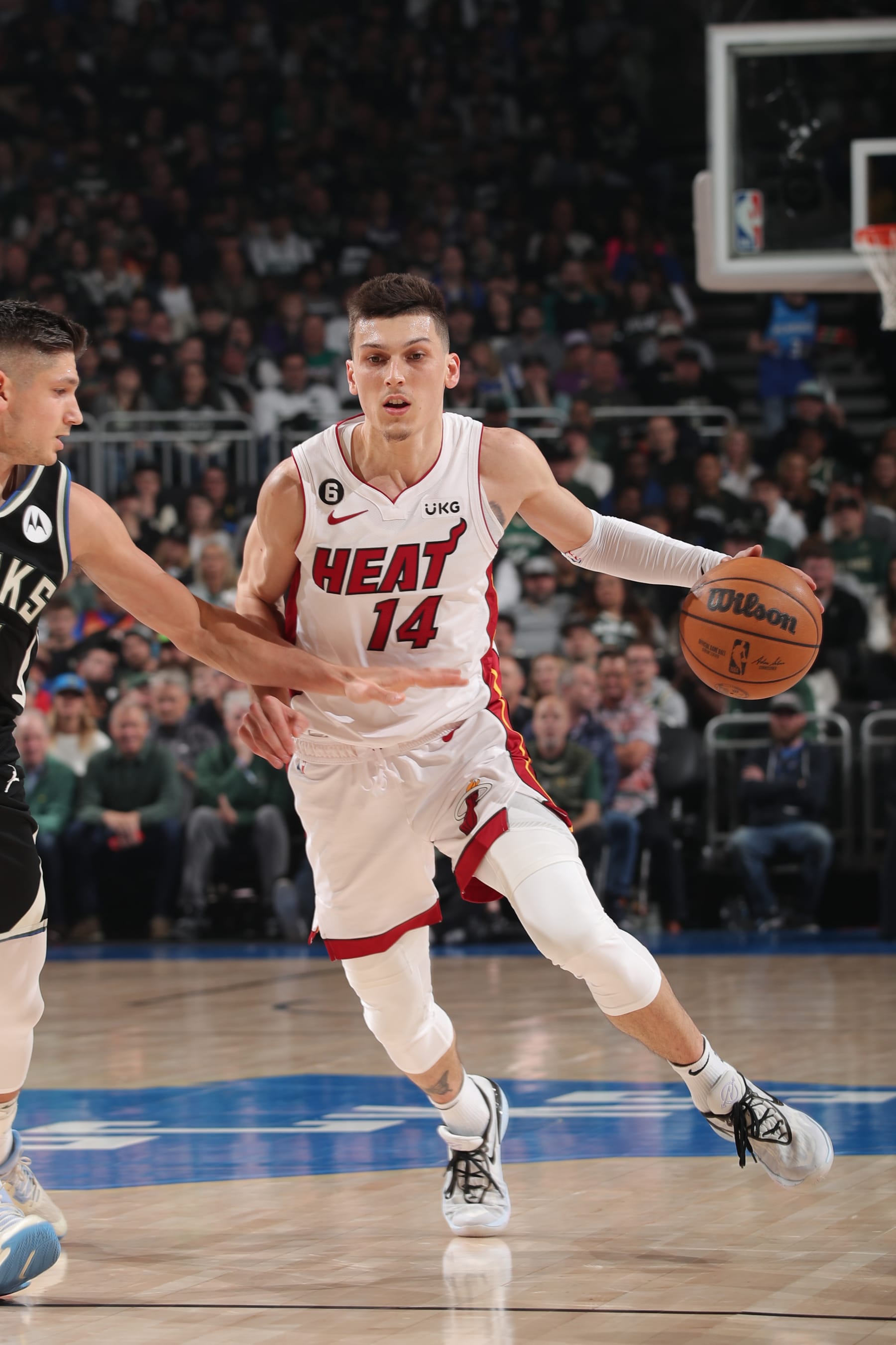 MILWAUKEE, WI - APRIL 16: Tyler Herro #14 of the Miami Heat dribbles the ball during the game against the Milwaukee Bucks during Round One Game One of the 2023 NBA Playoffs on April 16, 2023 at the Fiserv Forum Center in Milwaukee, Wisconsin. NOTE TO USER: User expressly acknowledges and agrees that, by downloading and or using this Photograph, user is consenting to the terms and conditions of the Getty Images License Agreement. Mandatory Copyright Notice: Copyright 2023 NBAE (Photo by Gary Dineen/NBAE via Getty Images).