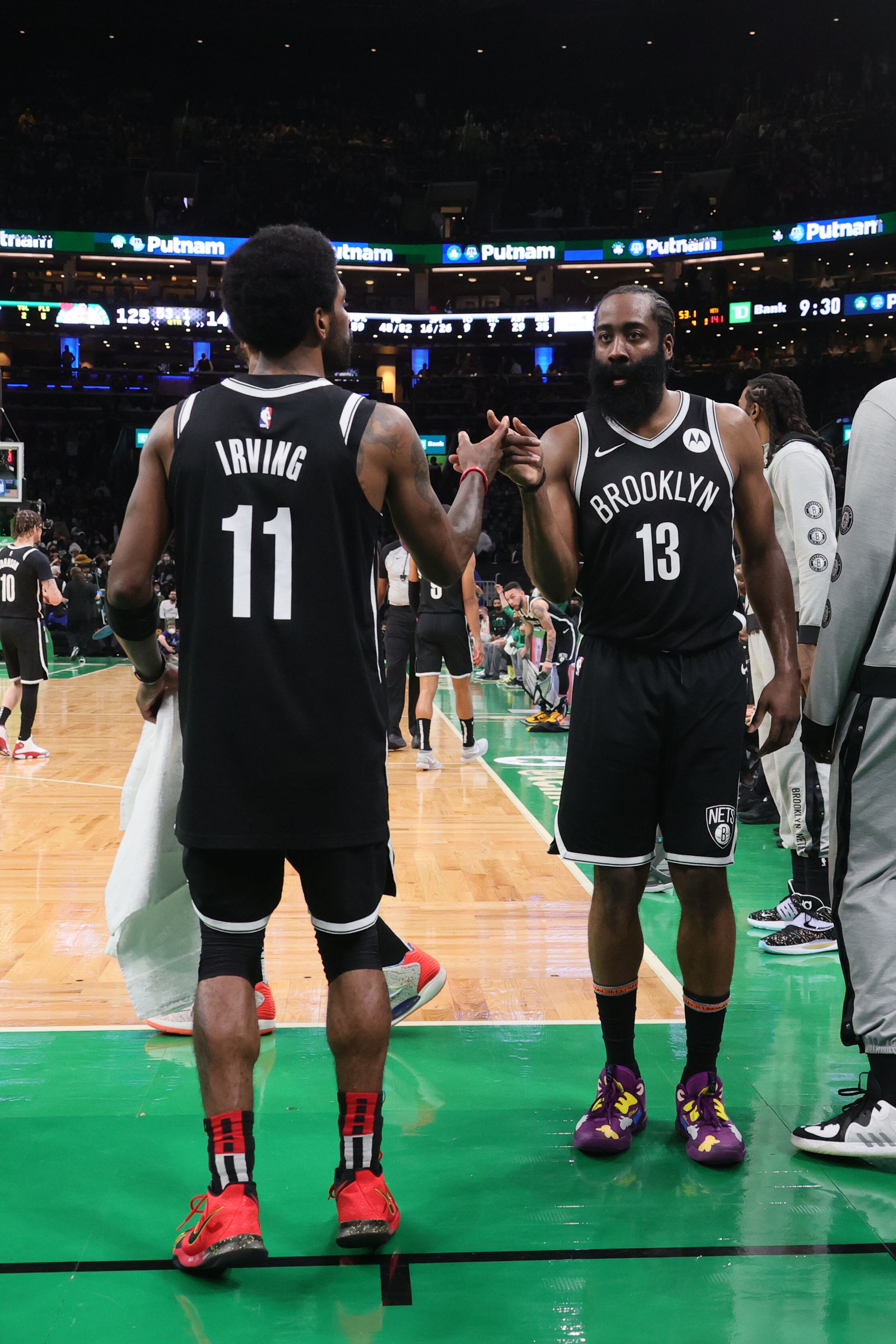 BOSTON, MA - MAY 30: James Harden #13 hi-fives Kyrie Irving #11 of the Brooklyn Nets during the game against the Boston Celtics during Round 1, Game 4 of the 2021 NBA Playoffs on May 30, 2021 at the TD Garden in Boston, Massachusetts.  NOTE TO USER: User expressly acknowledges and agrees that, by downloading and or using this photograph, User is consenting to the terms and conditions of the Getty Images License Agreement. Mandatory Copyright Notice: Copyright 2021 NBAE  (Photo by Nathaniel S. Butler/NBAE via Getty Images)