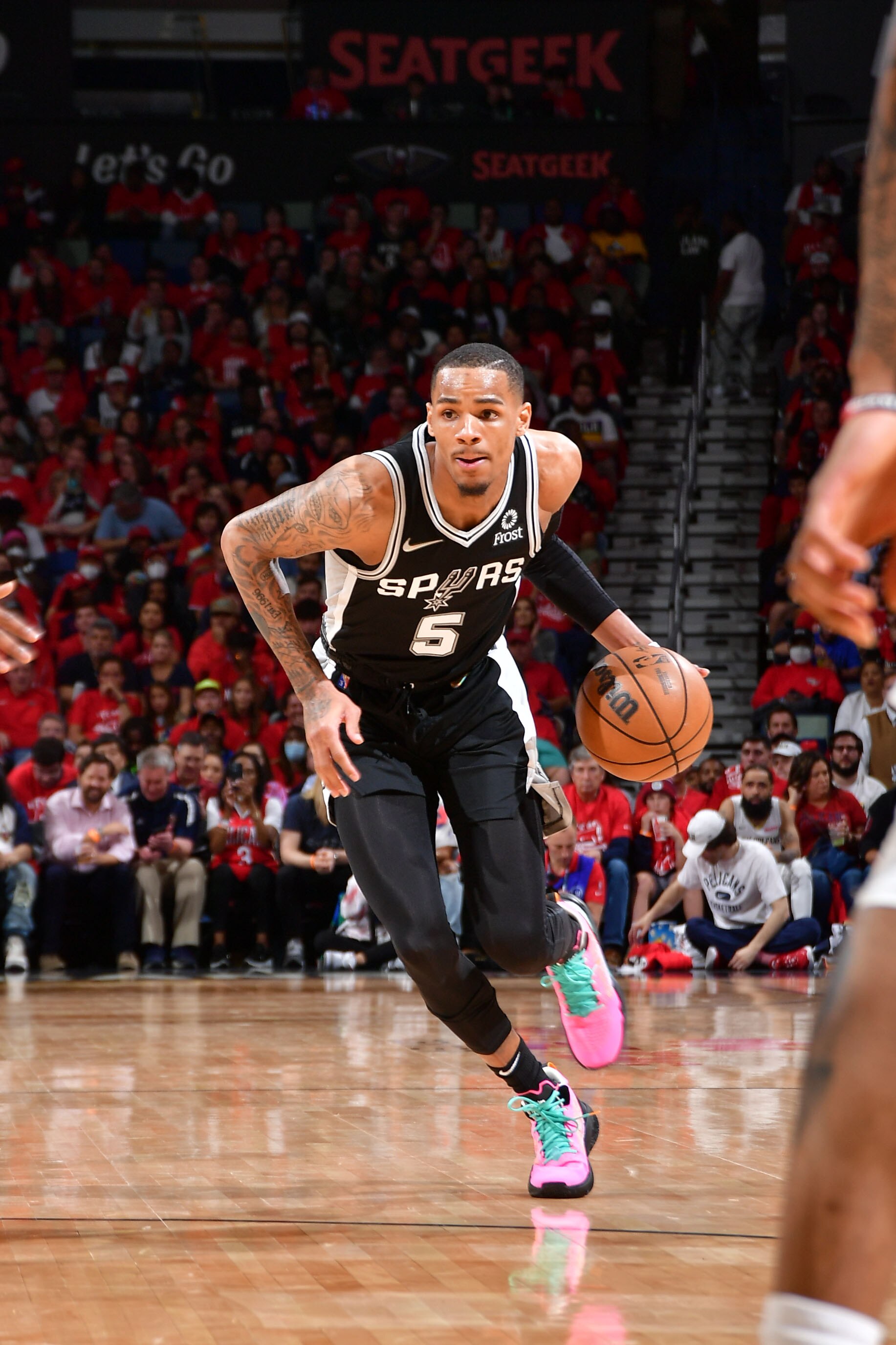 NEW ORLEANS, LA - APRIL 13: Dejounte Murray #5 of the San Antonio Spurs dribbles the ball during the game against the New Orleans Pelicans during the 2022 play-in tournament on April 13, 2022 at the Smoothie King Center in New Orleans, Louisiana. NOTE TO USER: User expressly acknowledges and agrees that, by downloading and or using this Photograph, user is consenting to the terms and conditions of the Getty Images License Agreement. Mandatory Copyright Notice: Copyright 2022 NBAE (Photo by Michael Gonzales/NBAE via Getty Images)