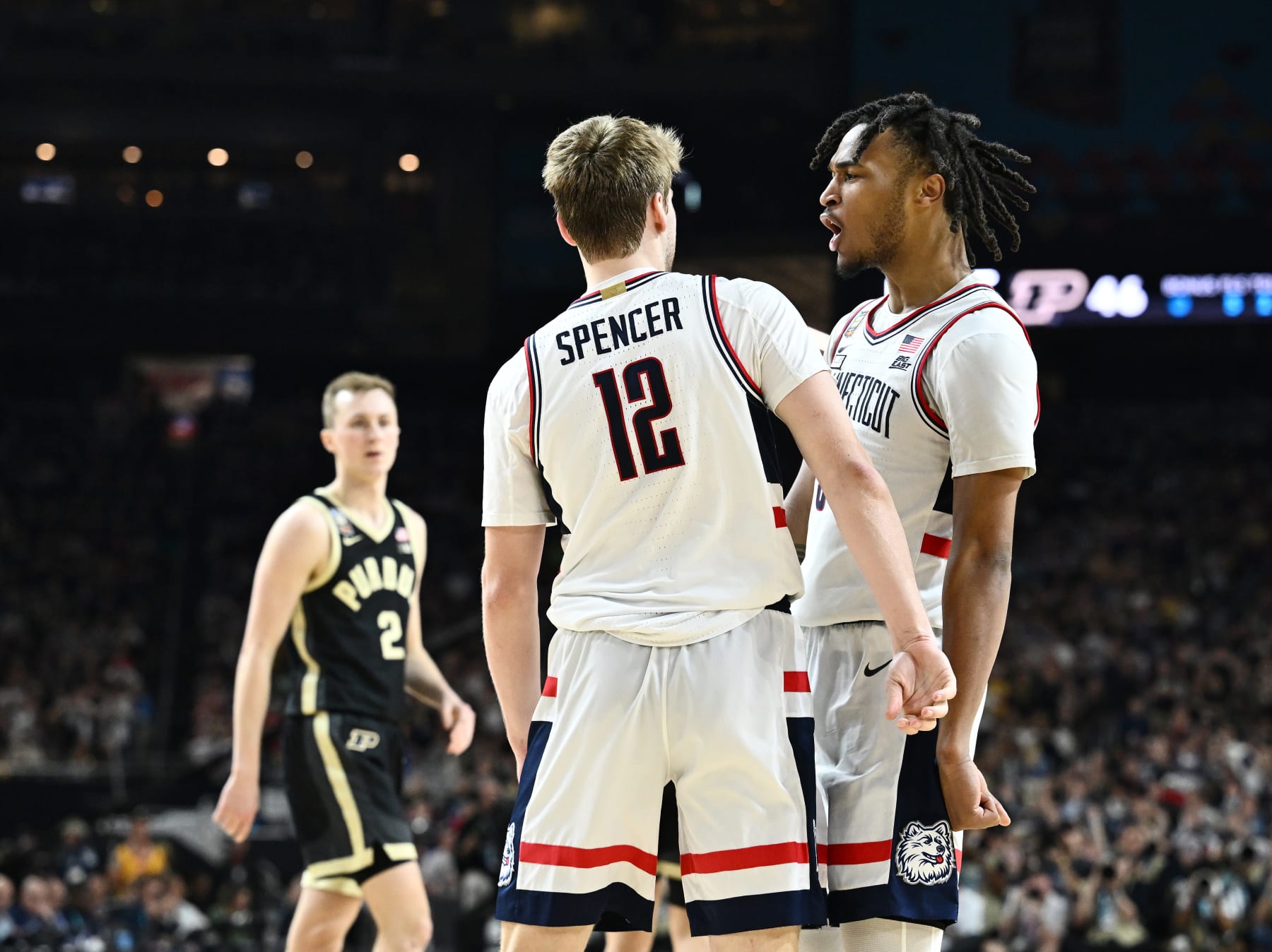 GLENDALE, ARIZONA - APRIL 08: Cam Spencer #12 of the Connecticut Huskies and Myles Colvin #5 of the Purdue Boilermakers react during the second half in the NCAA Men's Basketball Tournament National Championship game at State Farm Stadium on April 08, 2024 in Glendale, Arizona. (Photo by Brett Wilhelm/NCAA Photos via Getty Images)