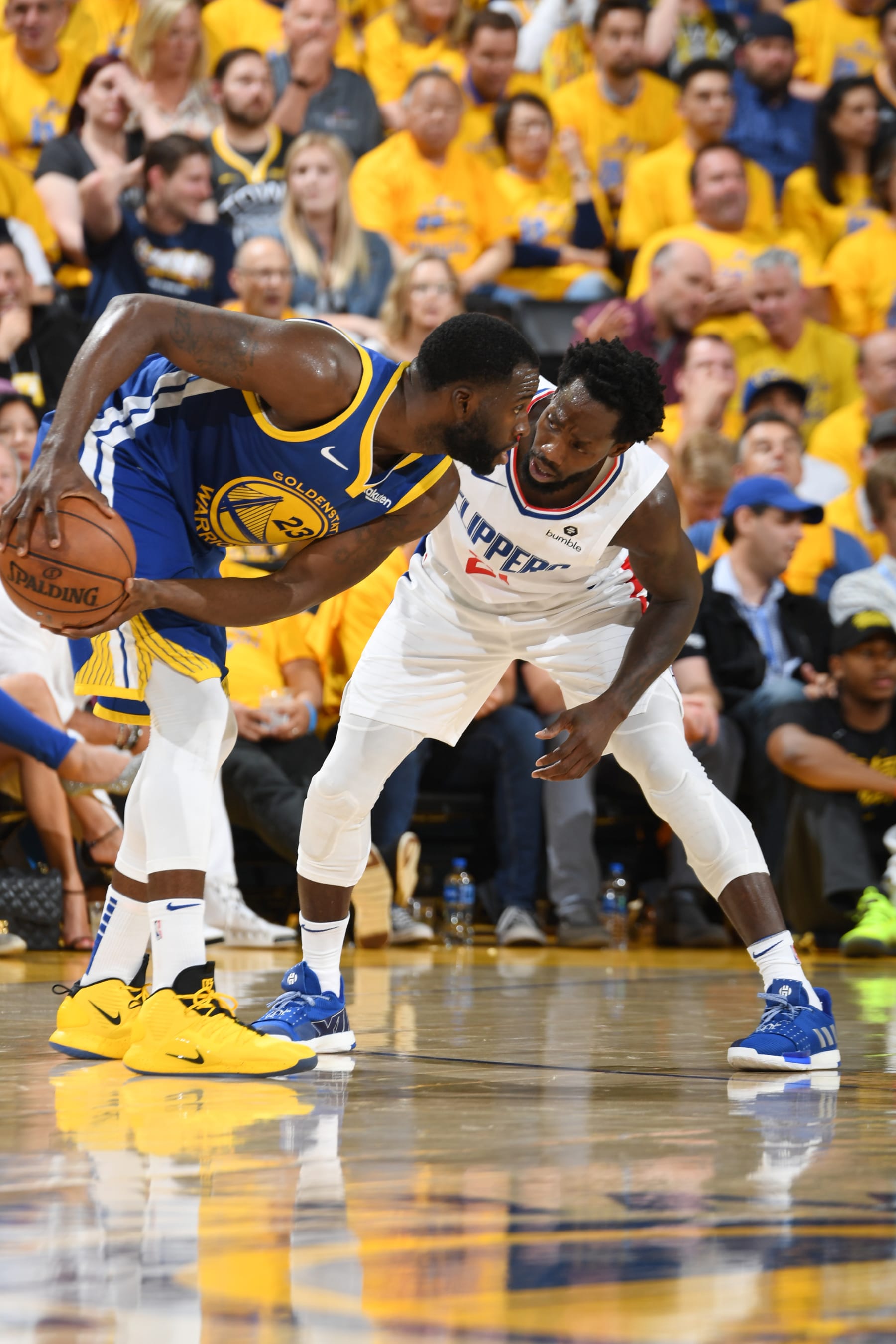 OAKLAND, CA - APRIL 24: Draymond Green #23 of the Golden State Warriors handles the ball against Patrick Beverley #21 of the LA Clippers during Game Five of Round One of the 2019 NBA Playoffs on April 24, 2019 at ORACLE Arena in Oakland, California. NOTE TO USER: User expressly acknowledges and agrees that, by downloading and or using this photograph, user is consenting to the terms and conditions of Getty Images License Agreement. Mandatory Copyright Notice: Copyright 2019 NBAE (Photo by Andrew D. Bernstein/NBAE via Getty Images)