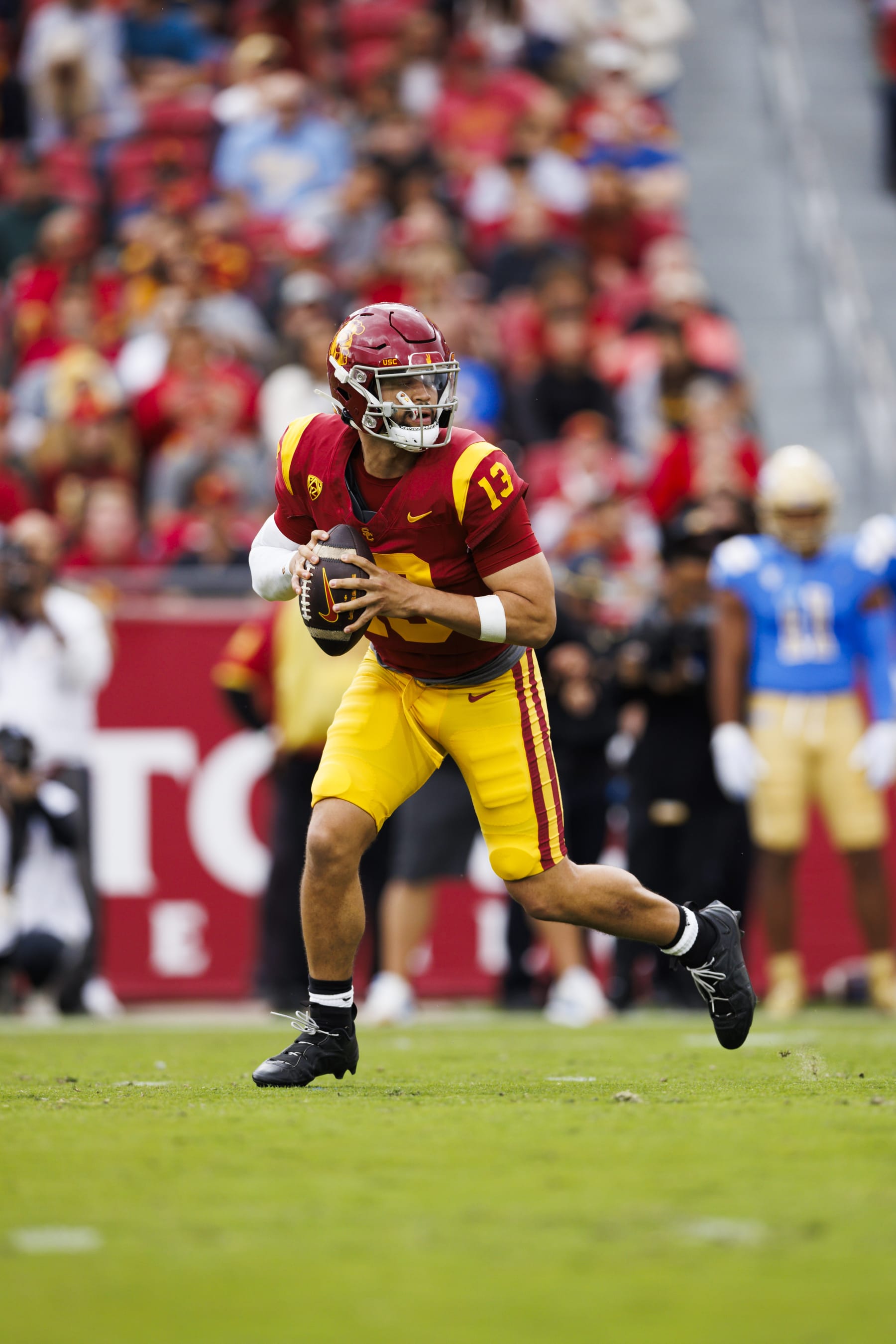 LOS ANGELES, CALIFORNIA - NOVEMBER 18: Caleb Williams #13 of the USC Trojans rolls out to pass during a game against the UCLA Bruins at United Airlines Field at the Los Angeles Memorial Coliseum on November 11, 2023 in Los Angeles, California. (Photo by Ric Tapia/Getty Images)