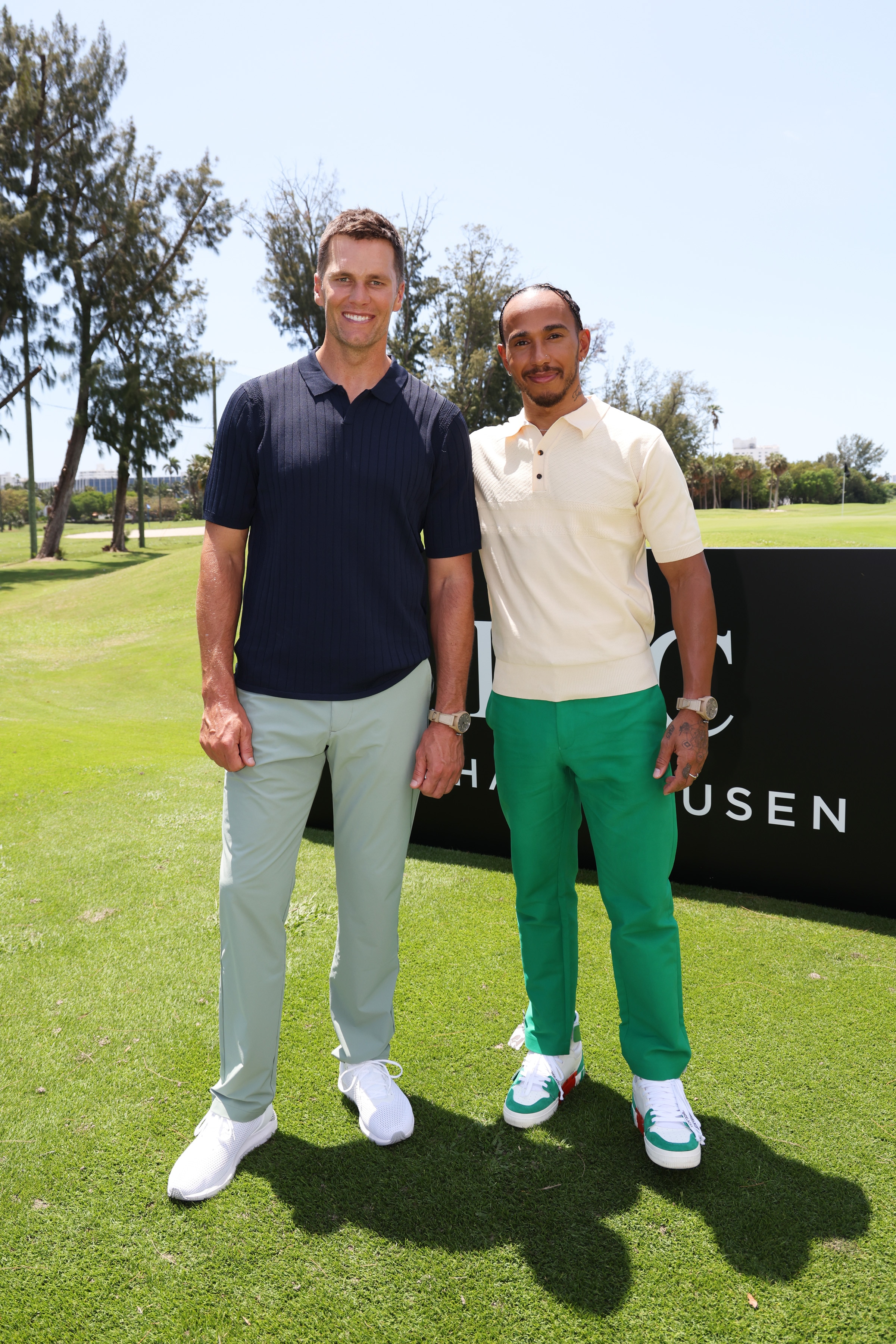 MIAMI BEACH, FLORIDA - MAY 04: IWC brand ambassador and seven-time World Champion quarterback Tom Brady and IWC brand ambassador and seven-time Formula One World Champion Lewis Hamilton during The Big Pilot Challenge, an entertaining charity golf challenge organized by IWC Schaffhausen at the Miami Beach Golf Club on May 4, 2022 in Miami Beach, Florida. (Photo by Alexander Tamargo/Getty Images for IWC Schaffhausen)