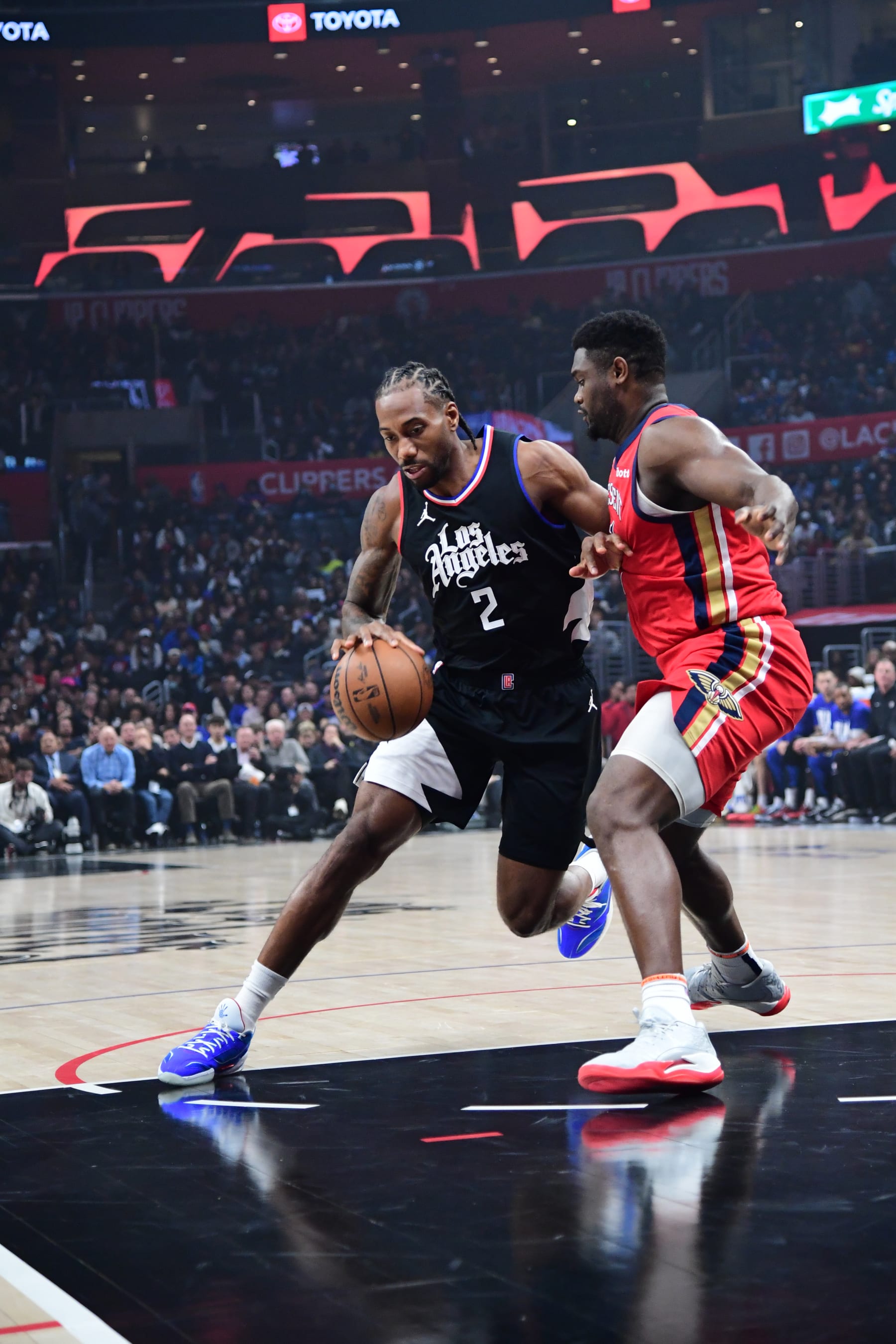 LOS ANGELES, CA - FEBRUARY 7: Kawhi Leonard #2 of the LA Clippers drives to the basket against Zion Williamson #1 of the New Orleans Pelicans during the game on February 7, 2024 at Crypto.Com Arena in Los Angeles, California. NOTE TO USER: User expressly acknowledges and agrees that, by downloading and/or using this Photograph, user is consenting to the terms and conditions of the Getty Images License Agreement. Mandatory Copyright Notice: Copyright 2024 NBAE (Photo by Adam Pantozzi/NBAE via Getty Images)