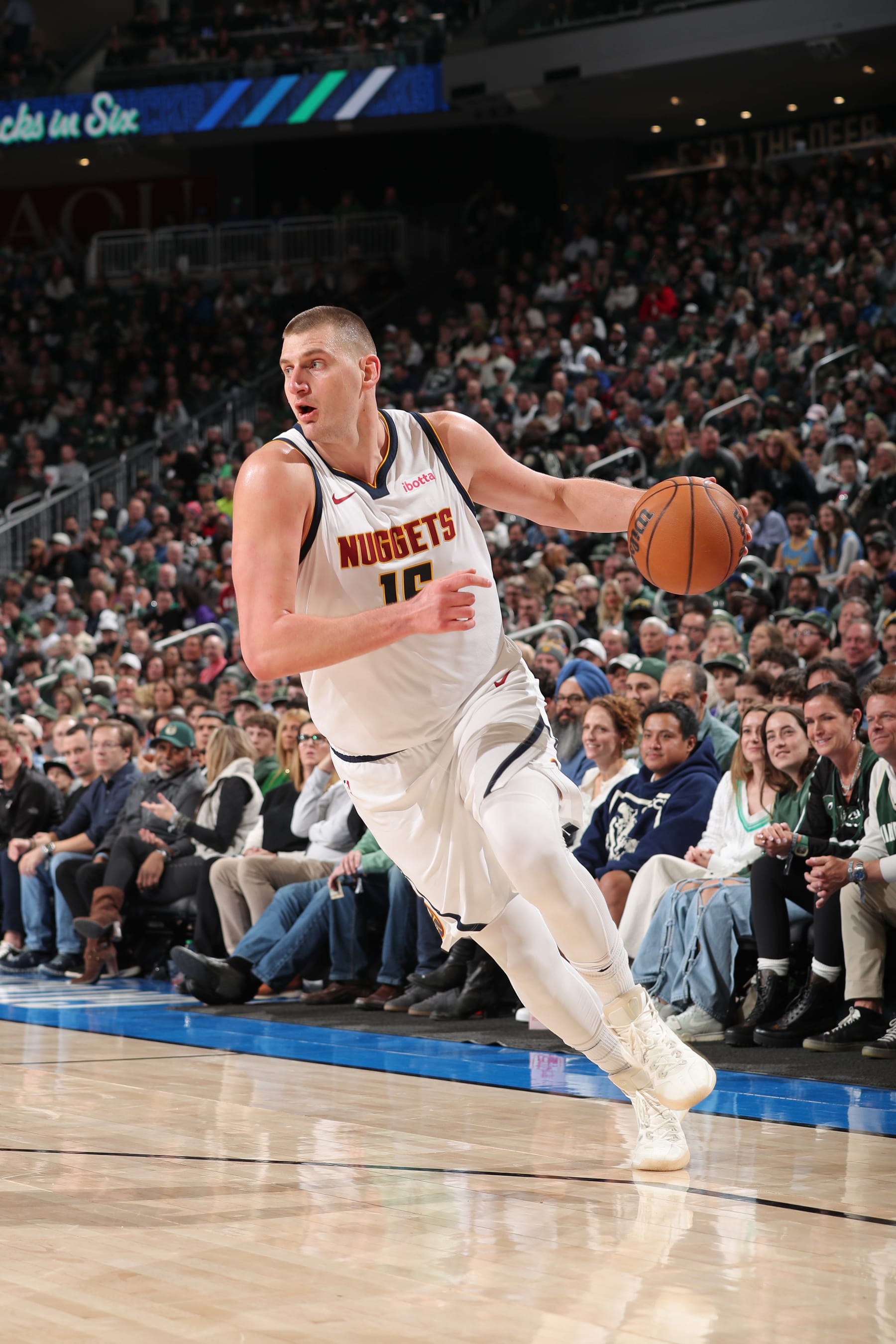 MILWAUKEE, WI - FEBRUARY 12: Nikola Jokic #15 of the Denver Nuggets handles the ball during the game against the Milwaukee Bucks on February 12, 2024 at the Fiserv Forum Center in Milwaukee, Wisconsin. NOTE TO USER: User expressly acknowledges and agrees that, by downloading and or using this Photograph, user is consenting to the terms and conditions of the Getty Images License Agreement. Mandatory Copyright Notice: Copyright 2024 NBAE (Photo by Gary Dineen/NBAE via Getty Images).
