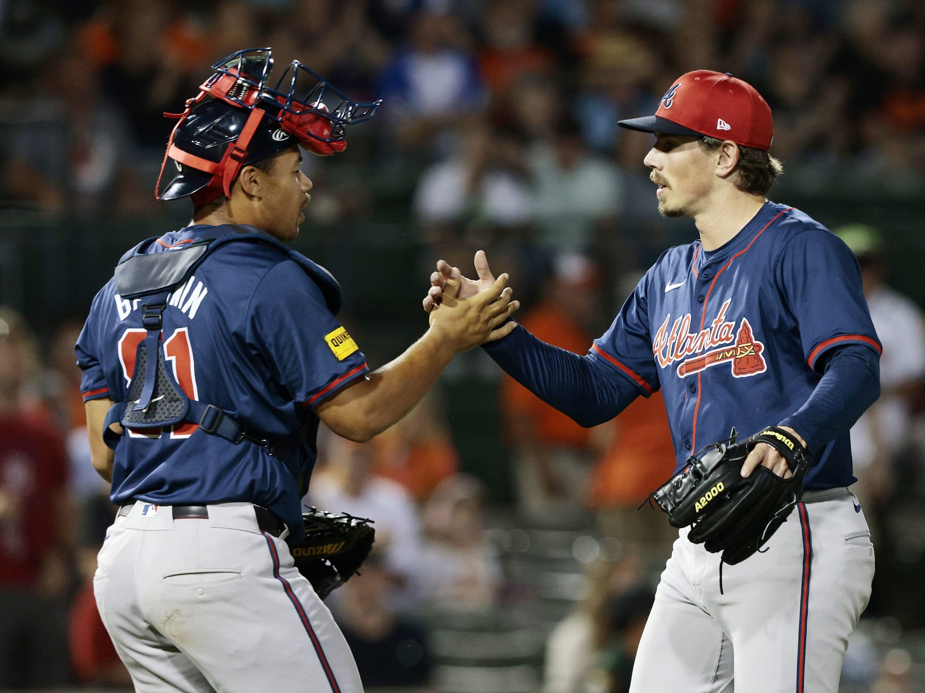 SARASOTA, FLORIDA - MARCH 13: Parker Dunshee #93 of the Atlanta Braves is congratulated by teammate Drake Baldwin #81 after the final out of a spring training game against the Baltimore Orioles at Ed Smith Stadium on March 13, 2024 in Sarasota, Florida. The Braves defeated the Orioles 7-5. (Photo by Christopher Pasatieri/Getty Images)