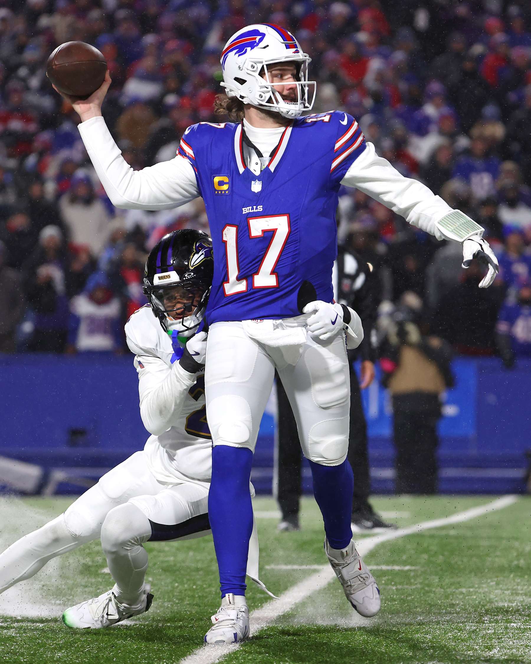 ORCHARD PARK, NEW YORK - JANUARY 19: Josh Allen #17 of the Buffalo Bills is chased by Nate Wiggins #2 of the Baltimore Ravens in the third quarter during the AFC Divisional Playoff at Highmark Stadium on January 19, 2025 in Orchard Park, New York.  (Photo by Timothy T Ludwig/Getty Images)