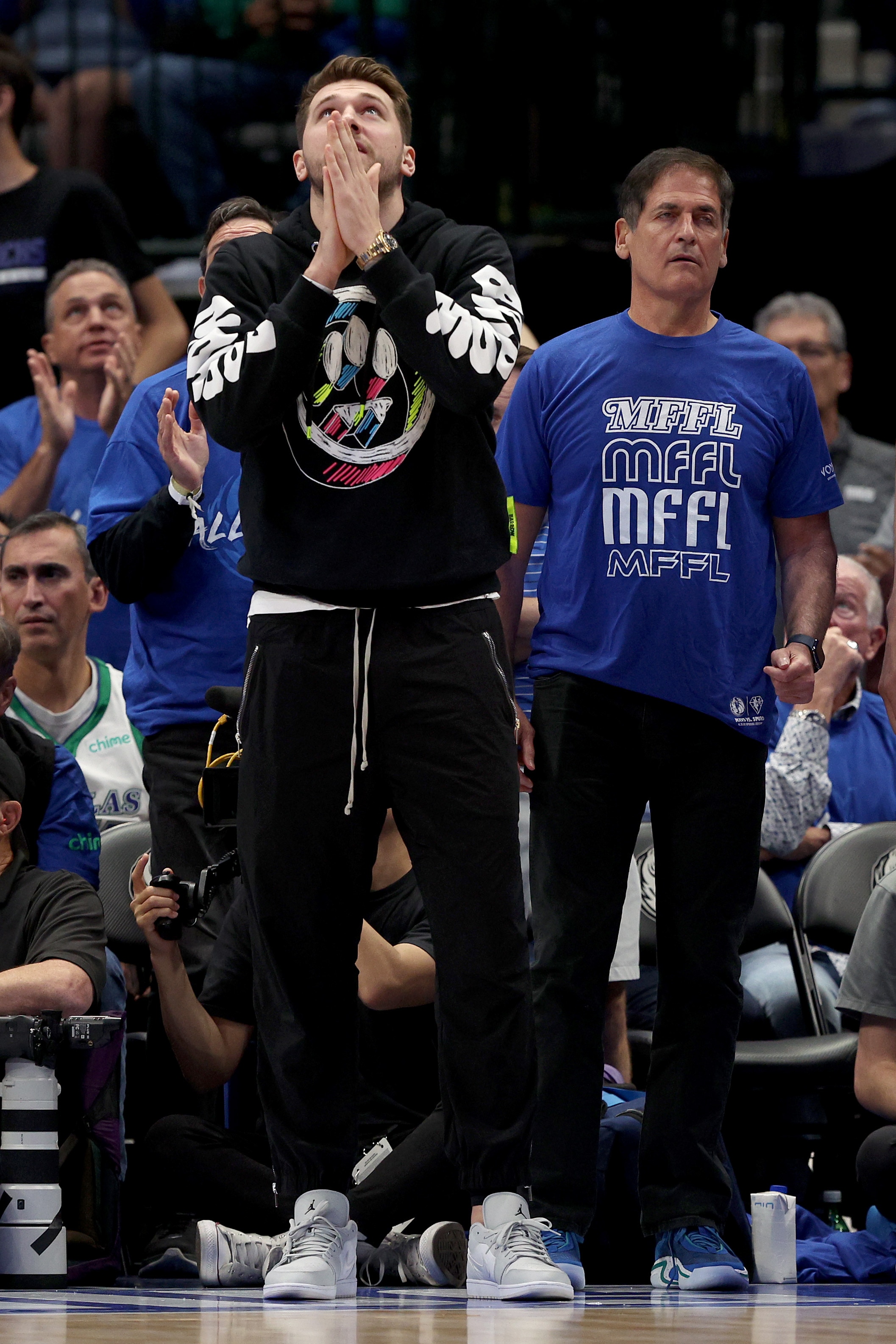 DALLAS, TEXAS - APRIL 16: Luka Doncic #77 of the Dallas Mavericks and team owner Mark Cuban of the Dallas Mavericks look on from the bench as the Dallas Mavericks take on the Utah Jazz in the second quarter of Game One of the Western Conference First Round NBA Playoffs at American Airlines Center on April 16, 2022 in Dallas, Texas. NOTE TO USER: User expressly acknowledges and agrees that, by downloading and or using this photograph, User is consenting to the terms and conditions of the Getty Images License Agreement. (Photo by Tom Pennington/Getty Images)