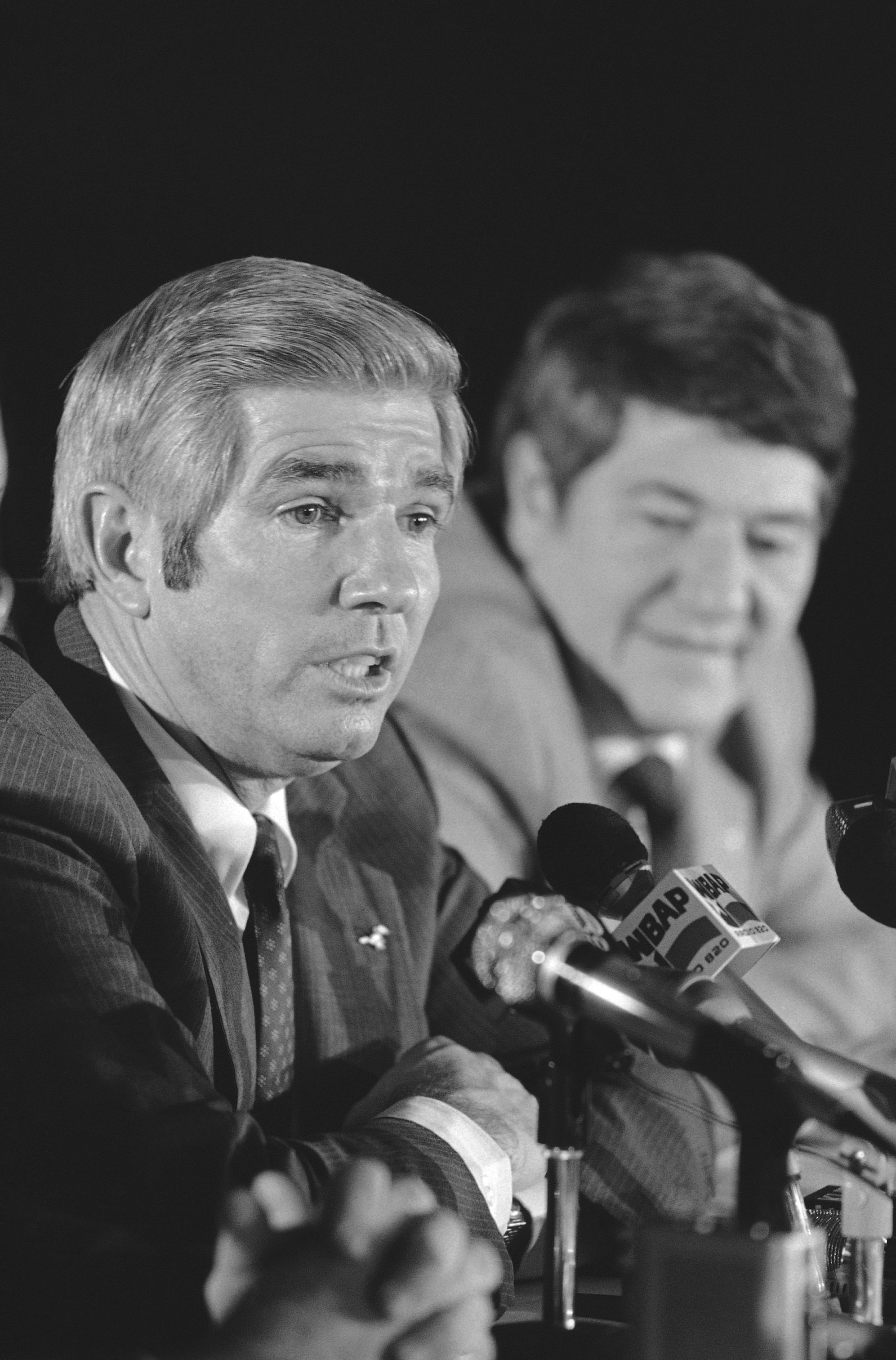 Bobby Collins speaks at a press conference in Dallas Monday, Jan. 18, 1982, after it was announced he would be the head football coach at Southern Methodist University. Collins replaces Ron Meyer, who resigned on Friday to become coach of the New England Patriots. The 48-year old Collins coached seven years at the University of Southern Miss. Bob Hitch, SMU’s athletic director, sits with Collins. (AP Photo/RFH)