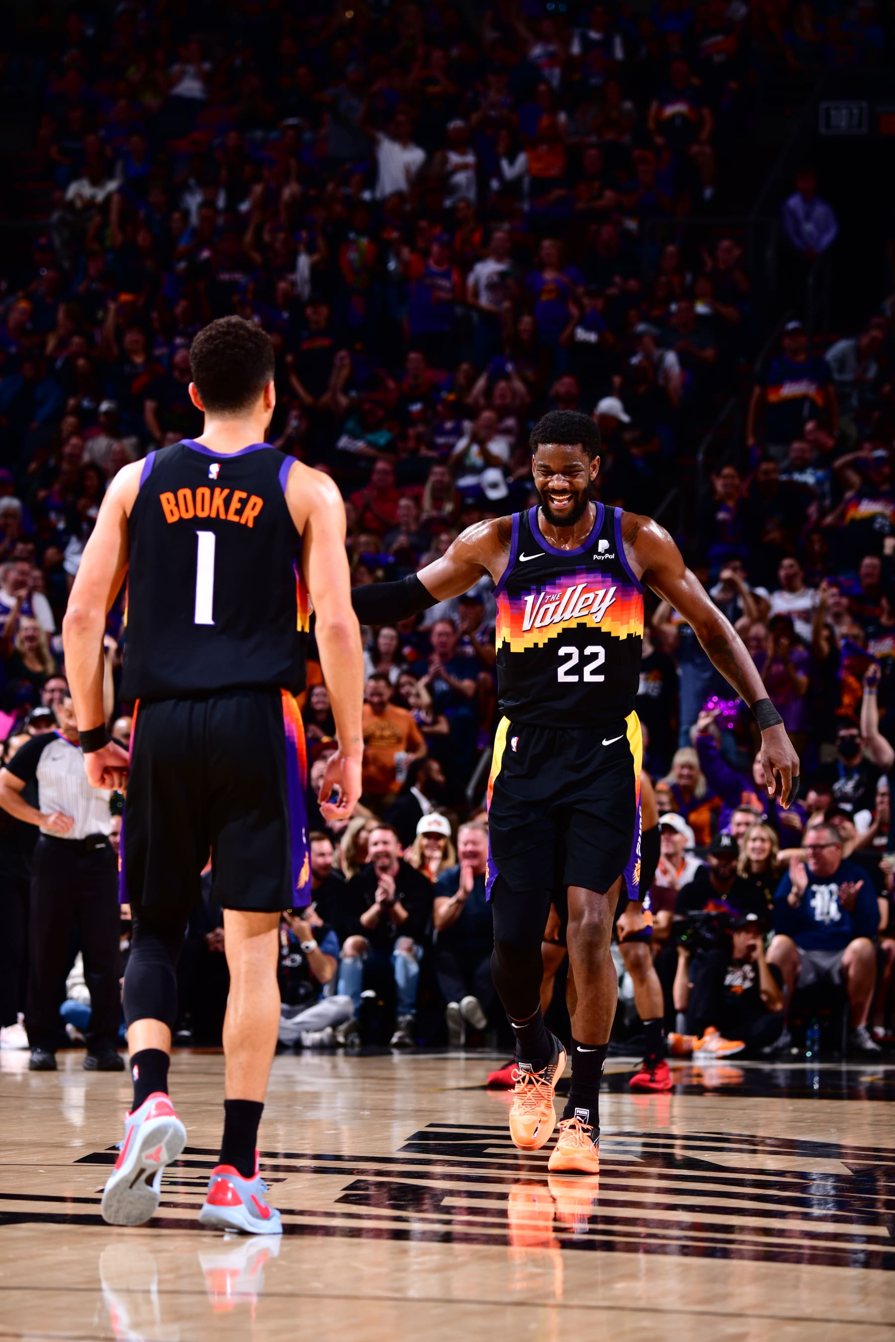 PHOENIX, AZ - MAY 2: Devin Booker #1 and Deandre Ayton #22 of the Phoenix Suns embrace during Game 1 of the 2022 NBA Playoffs Western Conference Semifinals on May 2, 2022 at Footprint Center in Phoenix, Arizona. NOTE TO USER: User expressly acknowledges and agrees that, by downloading and or using this photograph, user is consenting to the terms and conditions of the Getty Images License Agreement. Mandatory Copyright Notice: Copyright 2022 NBAE (Photo by Barry Gossage/NBAE via Getty Images)
