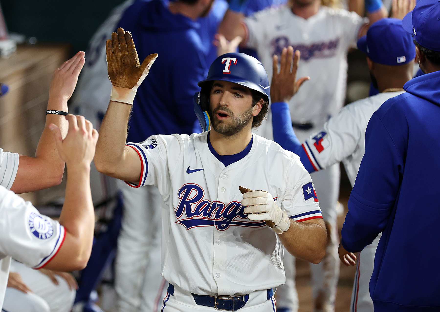 ARLINGTON, TEXAS - SEPTEMBER 21: Josh Smith #8 of the Texas Rangers celebrates in the dugout after a home run against the Seattle Mariners at Globe Life Field on September 21, 2024 in Arlington, Texas. (Photo by Richard Rodriguez/Getty Images)