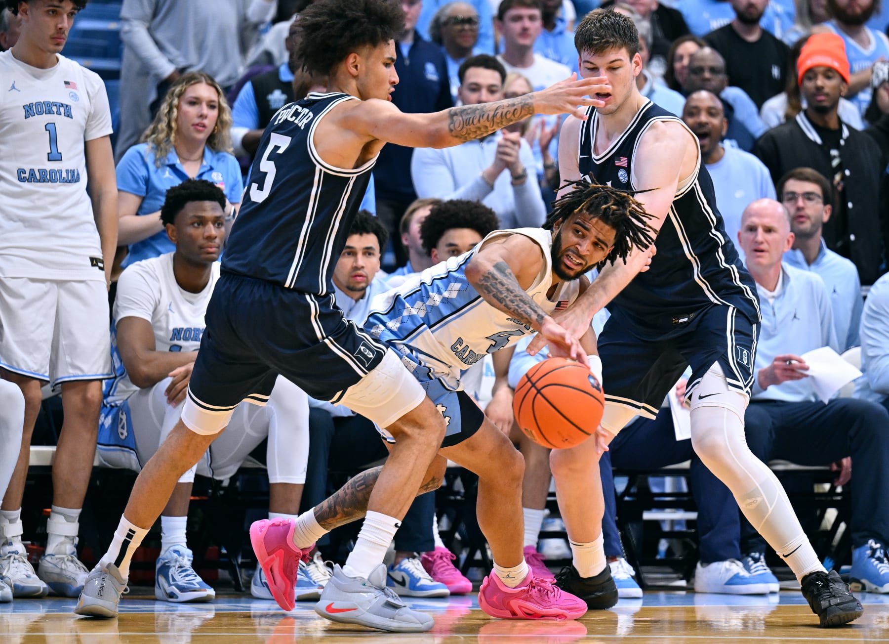 CHAPEL HILL, NORTH CAROLINA - FEBRUARY 03: Tyrese Proctor #5 and Kyle Filipowski #30 of the Duke Blue Devils defend RJ Davis #4 of the North Carolina Tar Heels during the second half of the game at the Dean E. Smith Center on February 03, 2024 in Chapel Hill, North Carolina. The Tar Heels won 93-84. (Photo by Grant Halverson/Getty Images)