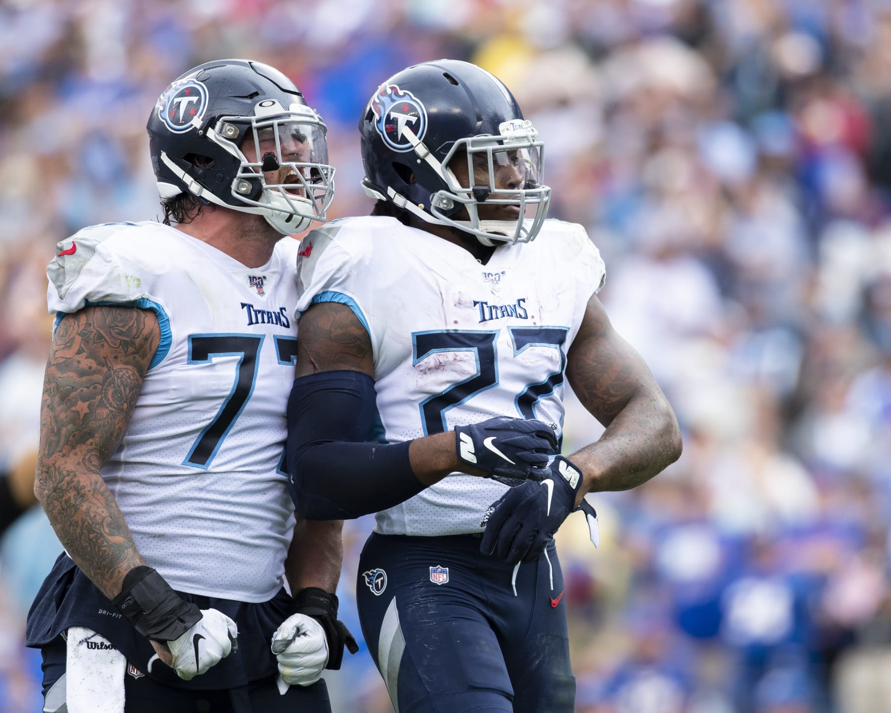 NASHVILLE, TN - OCTOBER 06:  Derrick Henry #22 of the Tennessee Titans celebrates a third quarter touchdown with Taylor Lewan #77 against the Buffalo Bills at Nissan Stadium on October 6, 2019 in Nashville, Tennessee. Buffalo defeats Tennessee 14-7.  (Photo by Brett Carlsen/Getty Images)
