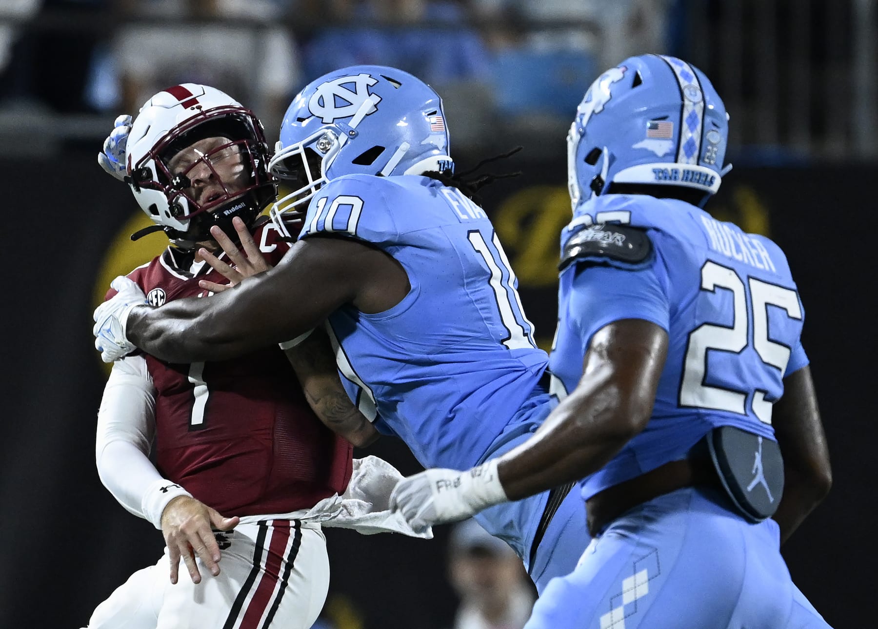 CHARLOTTE, NORTH CAROLINA - SEPTEMBER 02: Desmond Evans #10 of the North Carolina Tar Heels hits Spencer Rattler #7 of the South Carolina Gamecocks during the second half of the game at Bank of America Stadium on September 02, 2023 in Charlotte, North Carolina. North Carolina won 31-17. (Photo by Grant Halverson/Getty Images) CHARLOTTE, NORTH CAROLINA - SEPTEMBER 02: Desmond Evans #10 of the North Carolina Tar Heels hits Spencer Rattler #7 of the South Carolina Gamecocks during the second half of the game at Bank of America Stadium on September 02, 2023 in Charlotte, North Carolina. North Carolina won 31-17. (Photo by Grant Halverson/Getty Images)