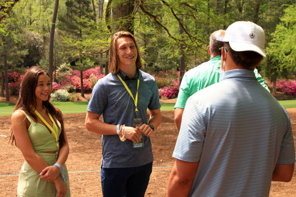 AUGUSTA, GEORGIA - APRIL 08: Former Clemson quarterback Trevor Lawrence (L) and his fiancé Marissa Mowry talk to Patrick Mahomes of the Kansas City Chiefsaas they watch play on the 13th hole during the first round of the Masters at Augusta National Golf Club on April 08, 2021 in Augusta, Georgia. (Photo by Mike Ehrmann/Getty Images)