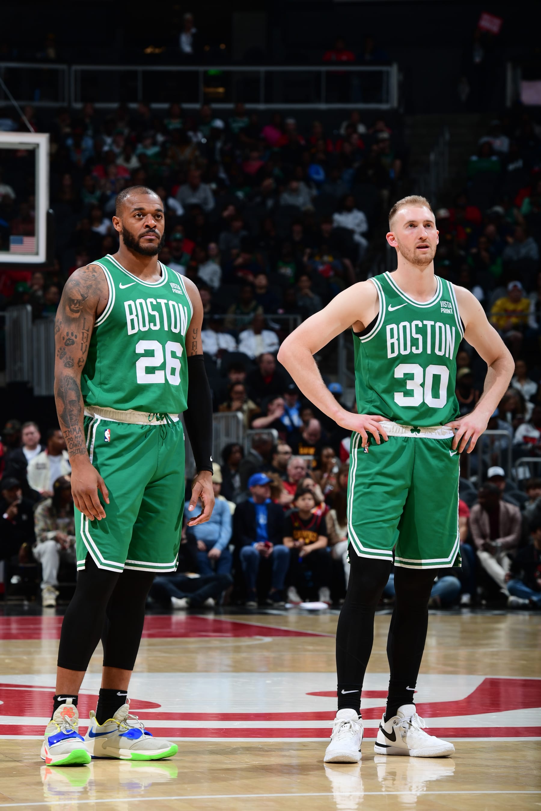 ATLANTA, GA - MARCH 28: Xavier Tillman #26 and Sam Hauser #30 of the Boston Celtics look on during the game against the Atlanta Hawks on March 28, 2024 at State Farm Arena in Atlanta, Georgia.  NOTE TO USER: User expressly acknowledges and agrees that, by downloading and/or using this Photograph, user is consenting to the terms and conditions of the Getty Images License Agreement. Mandatory Copyright Notice: Copyright 2024 NBAE (Photo by Scott Cunningham/NBAE via Getty Images)
